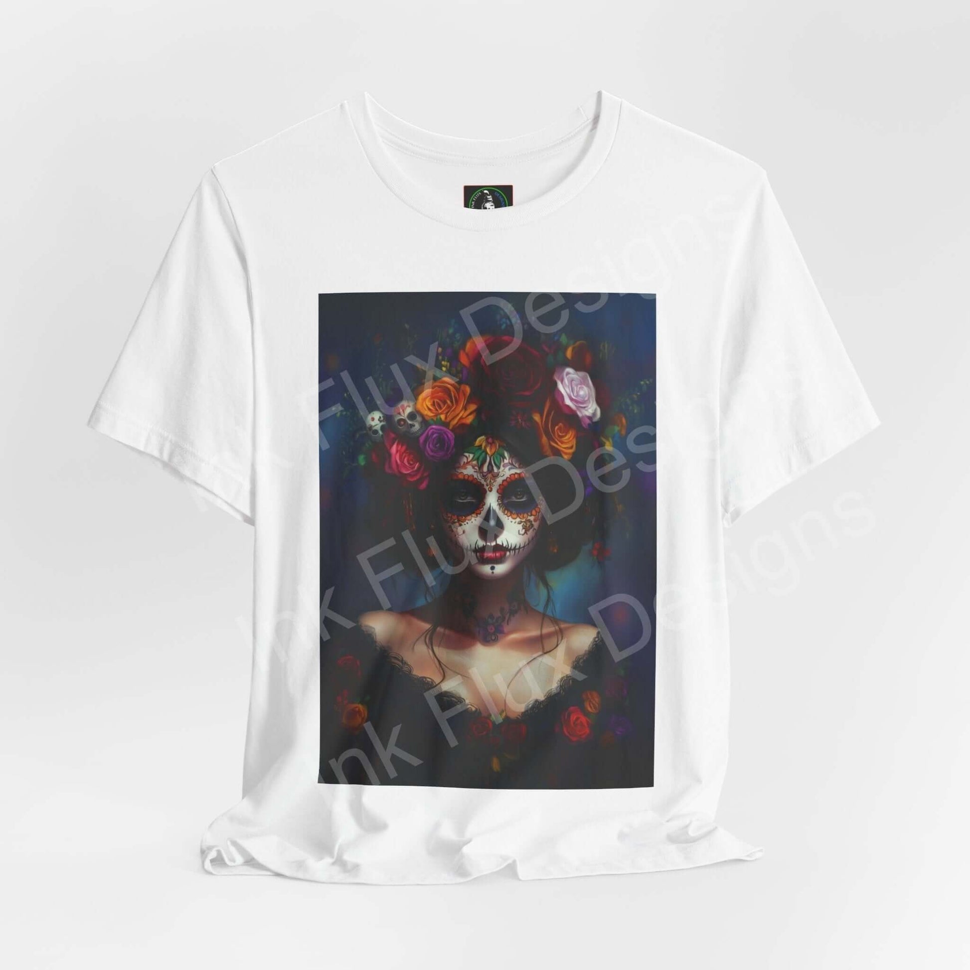 Day of the Dead themed graphic tee featuring a woman's portrait with DÃa de Muertos makeup, adorned with colorful floral designs, available in unisex sizes.