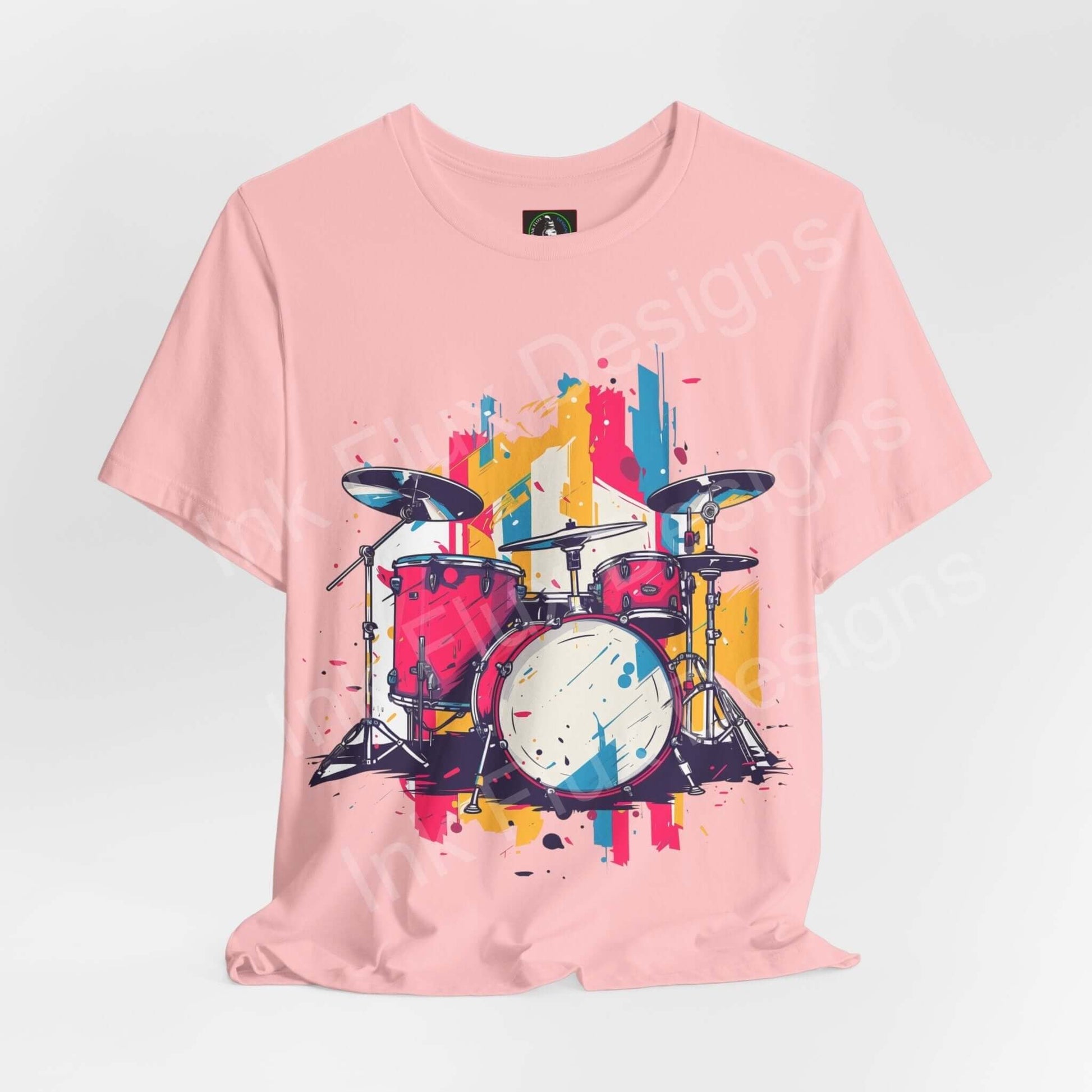 Pink unisex jersey T-shirt featuring a vibrant, graphic print of a drum set in bold colors by Bella+Canvas, ideal for style and comfort.