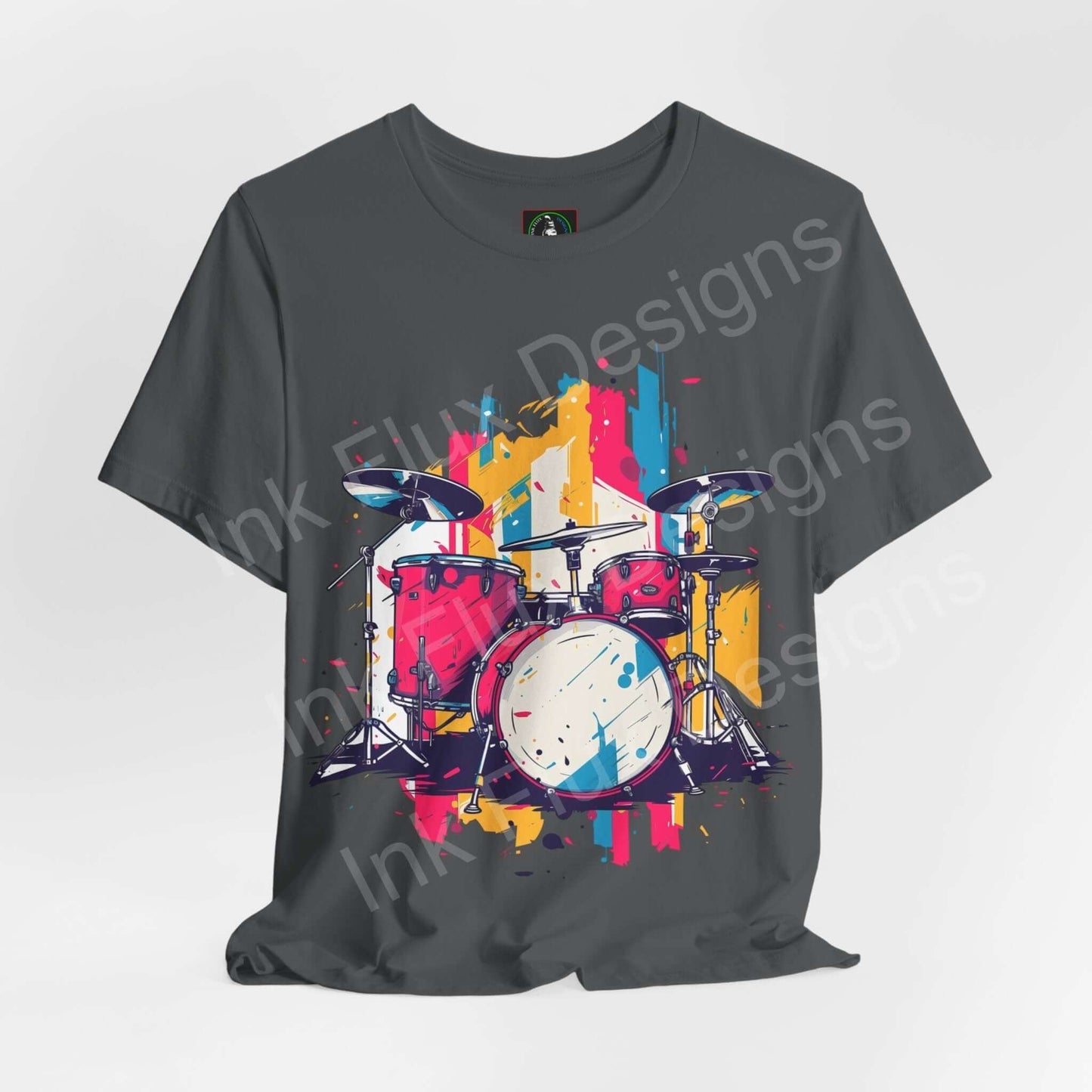 Gray unisex jersey T-shirt featuring a colorful, bold graphic of a drum set, designed for style and comfort, by Bella+Canvas.