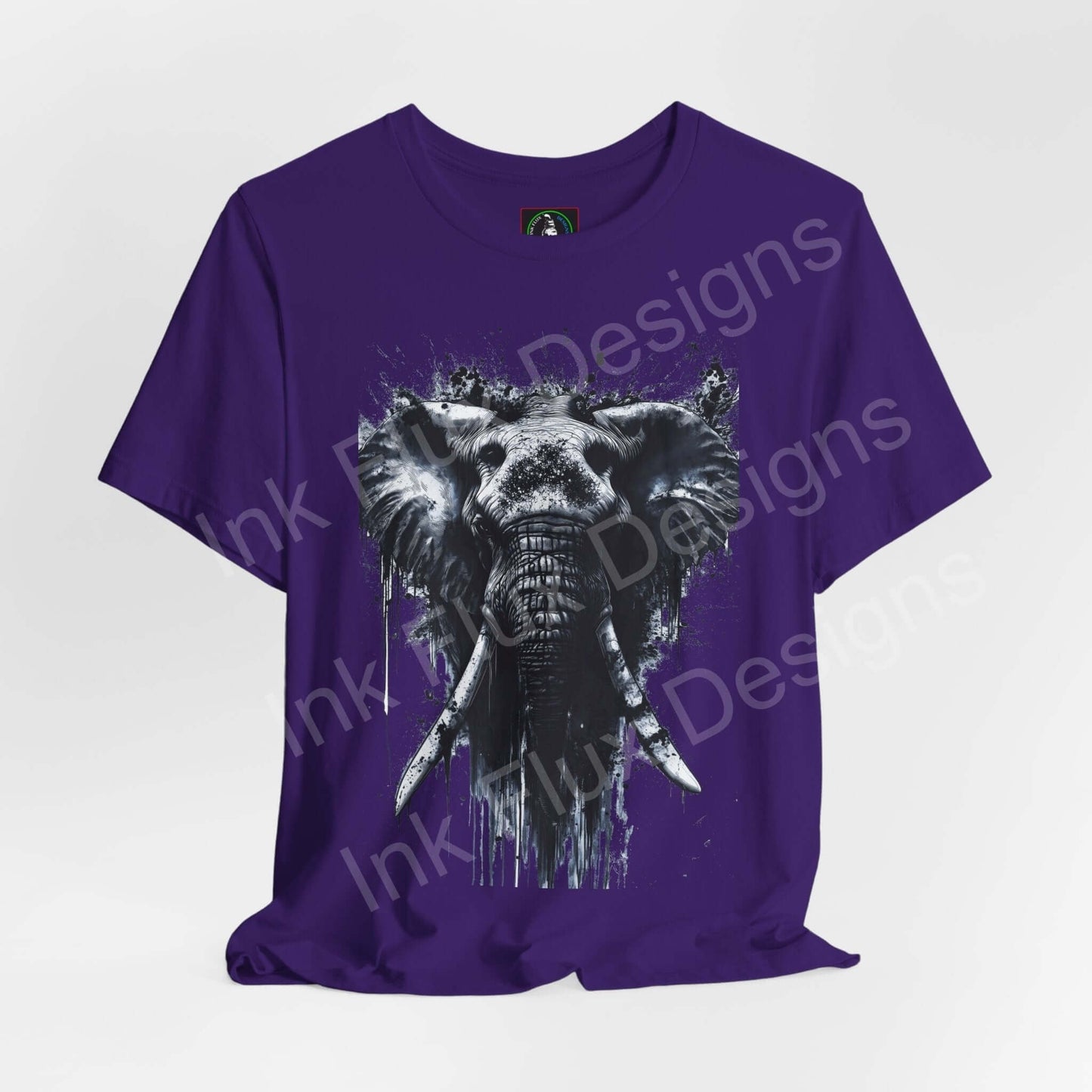 Purple unisex T-shirt featuring a white elephant spirit animal graphic, designed for style and comfort by Bella+Canvas.