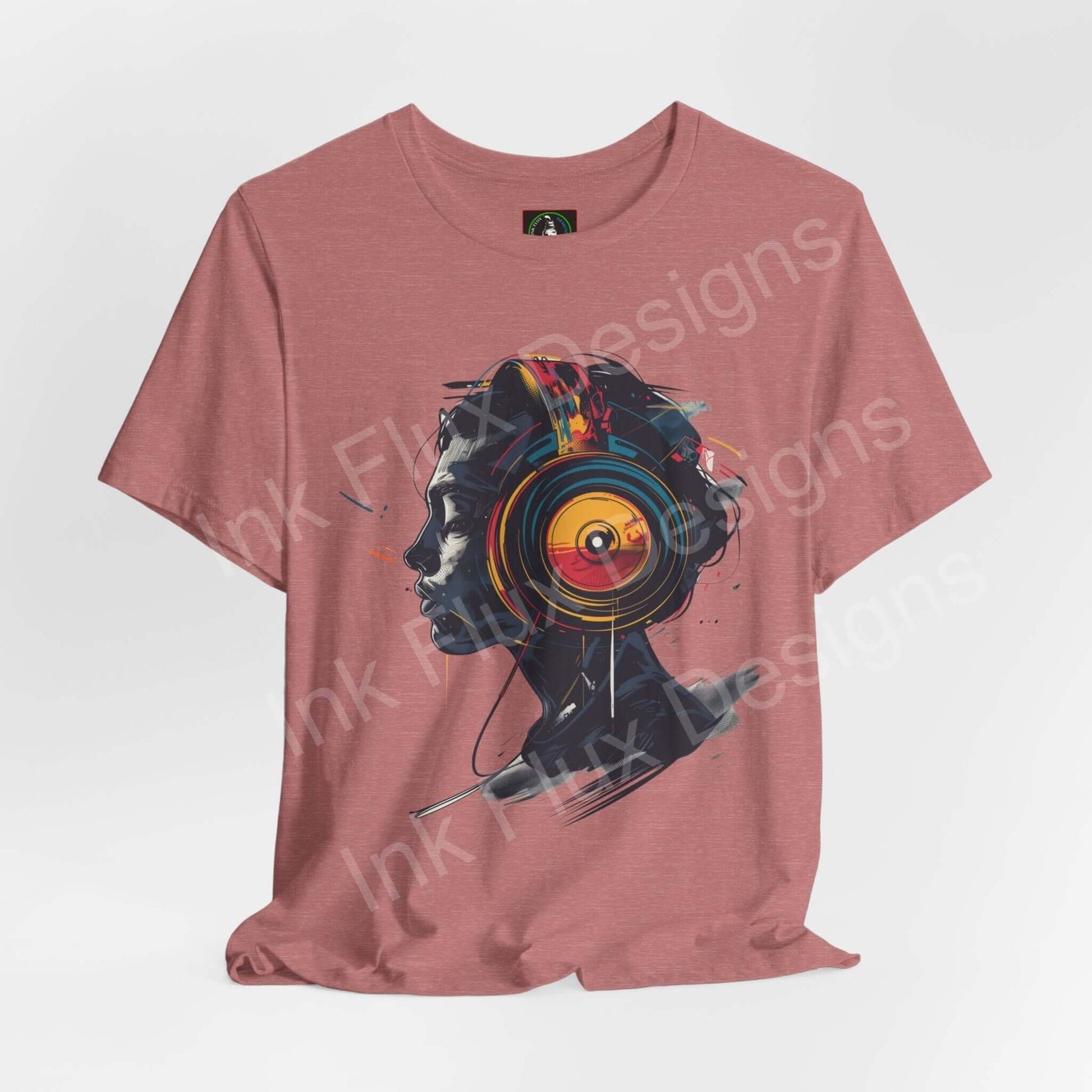 Unisex rose-colored T-shirt with bold graphic of abstract headphone design, made from breathable Airlume cotton, by Bella+Canvas.