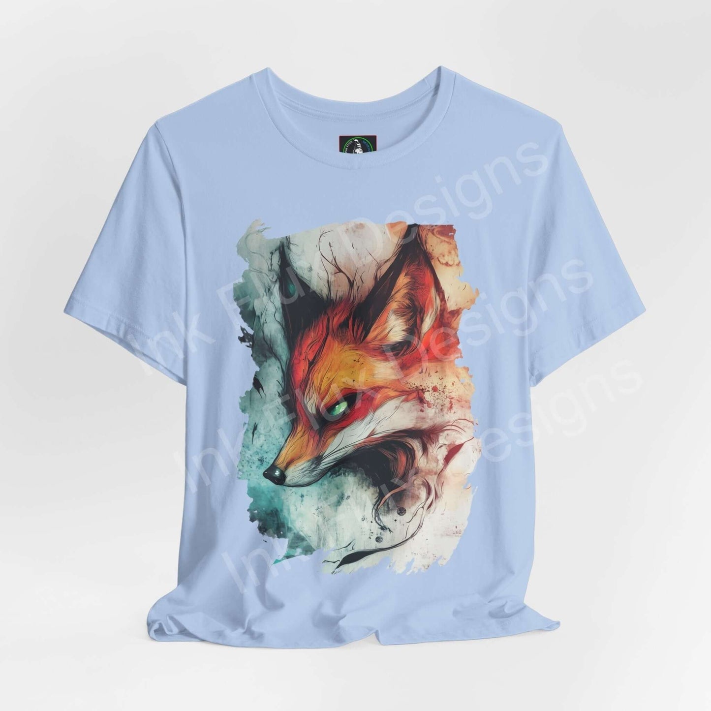 Light blue unisex T-shirt with vibrant Ethereal Fox graphic design, showcasing a stylized fox amidst splashes of color, ideal for fans of spirit animals and graphic tees.
