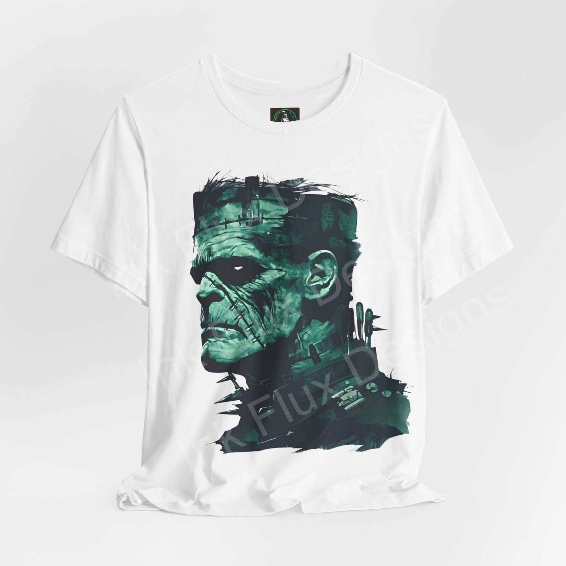 Unisex white graphic tee with a green Frankenstein design, perfect for Halloween, made from sustainable Airlume cotton by Bella+Canvas.