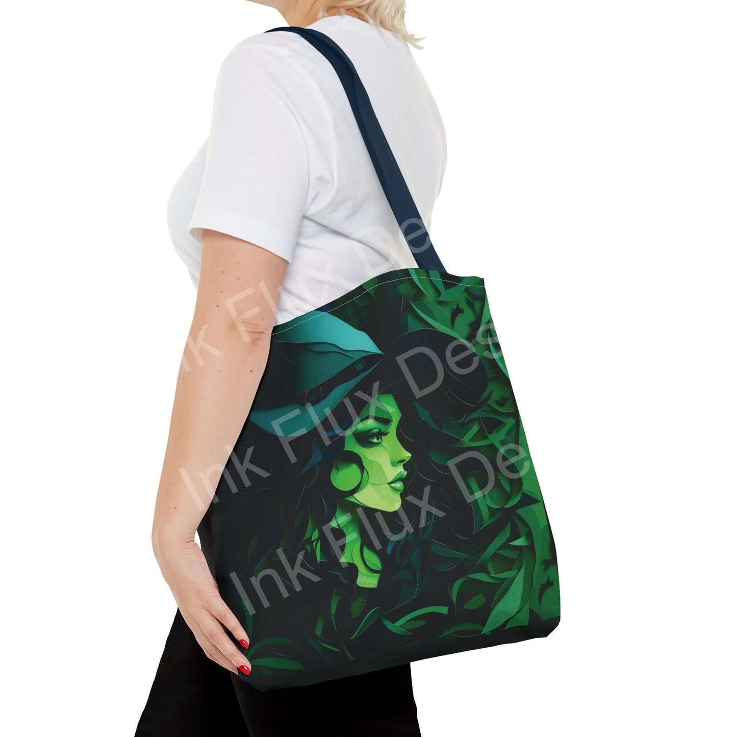 Woman carrying a green witch-themed all-over print tote bag, demonstrating both the design and style of the bag with a contrasting blue strap.