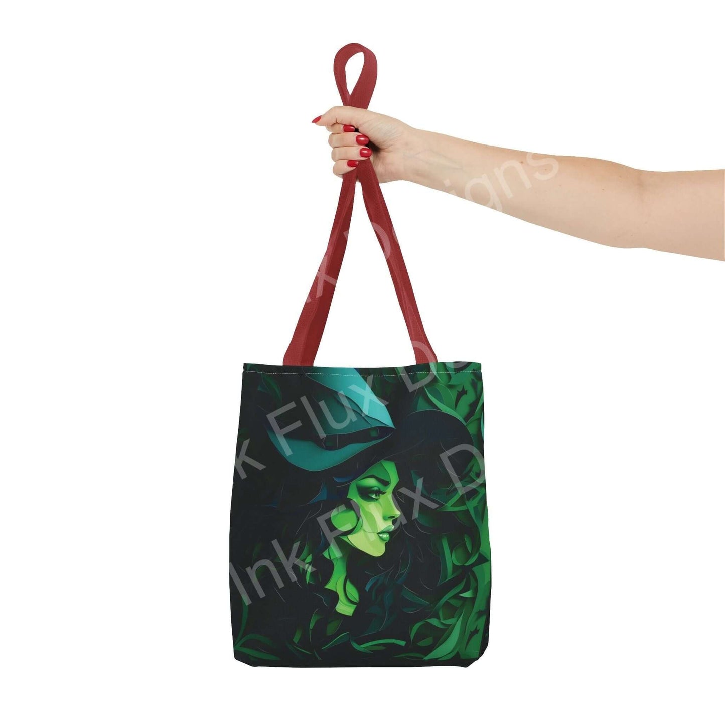 Hand holding a green witch themed all-over print tote bag with red straps, showcasing stylish and durable design.