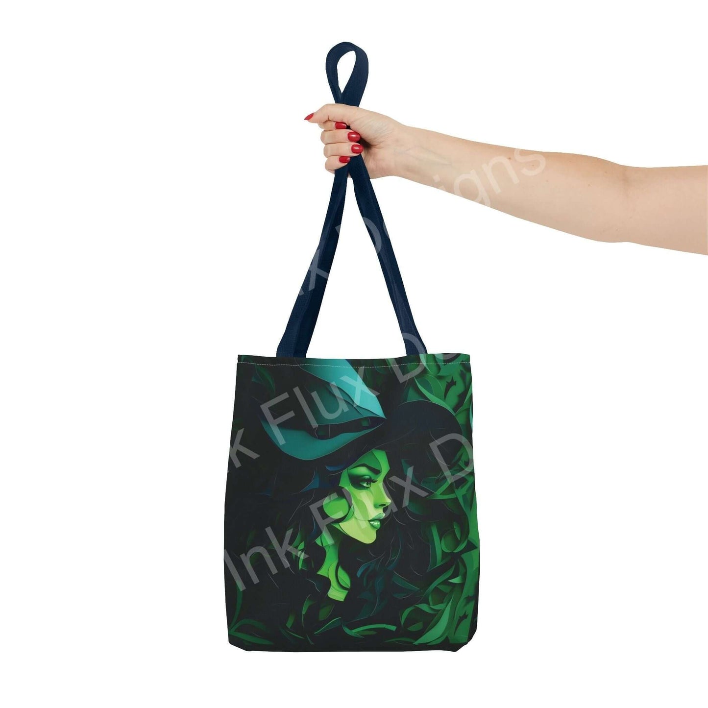 Woman's hand holding a green witch-themed all-over print tote bag with blue handles and stylish design, ideal for personal use or gifting.