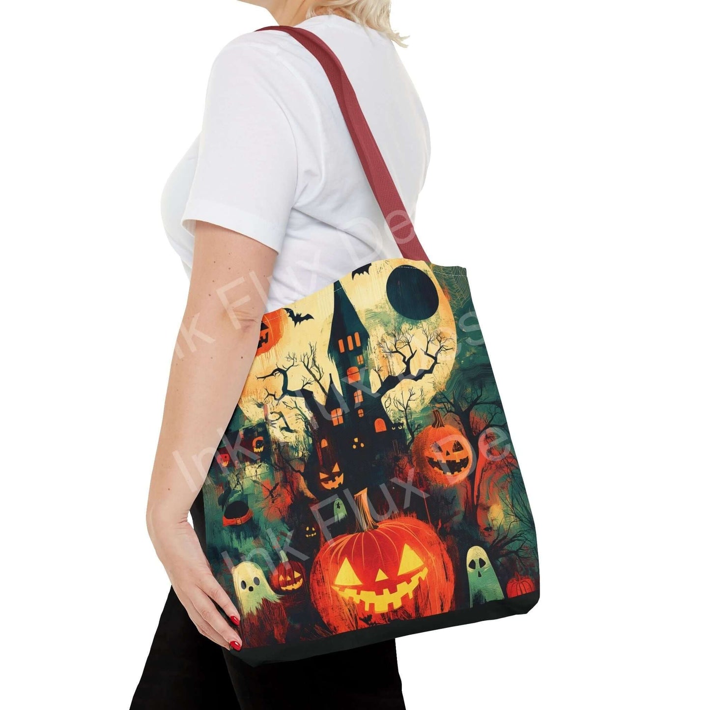 Woman carrying a Halloween-themed tote bag featuring vibrant all-over print of haunted house and pumpkins.