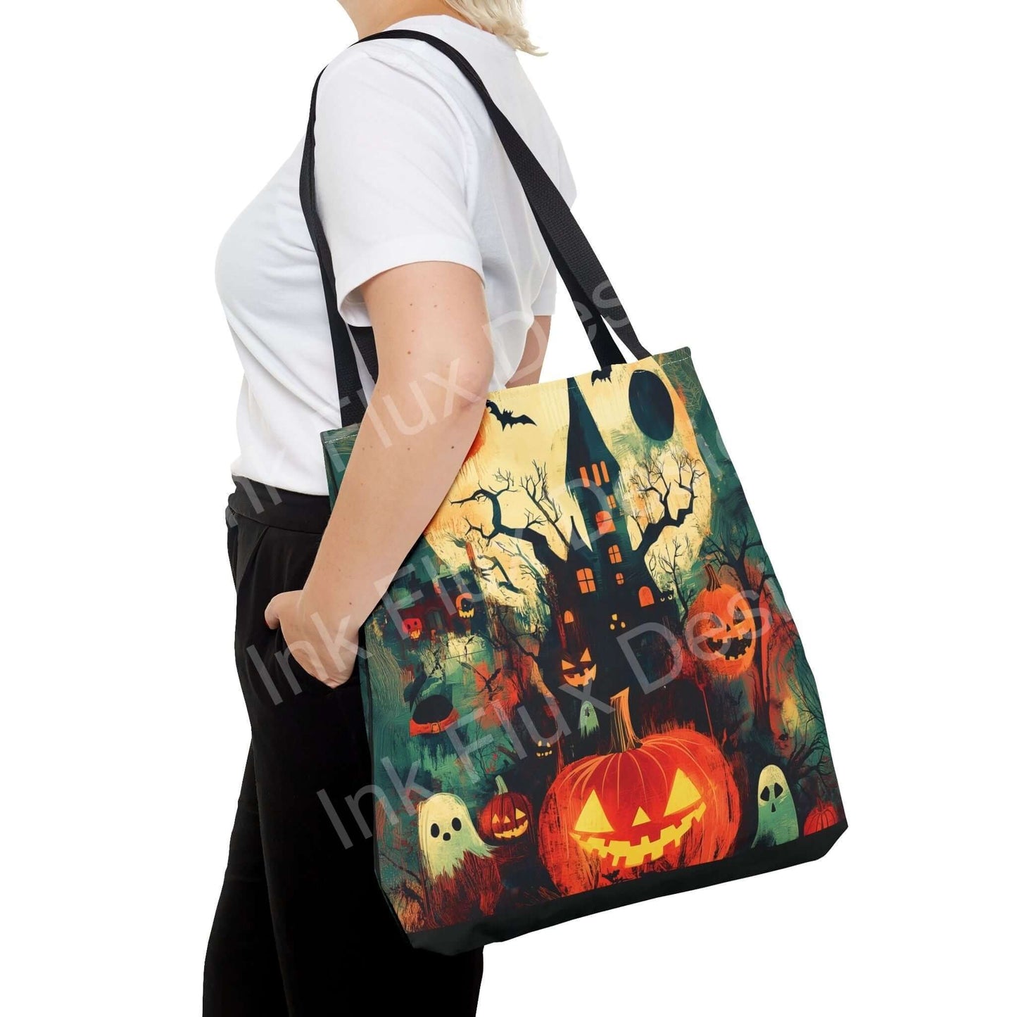 Woman carrying a Halloween themed tote bag featuring a vibrant all-over print of pumpkins, ghosts, and a haunted house.