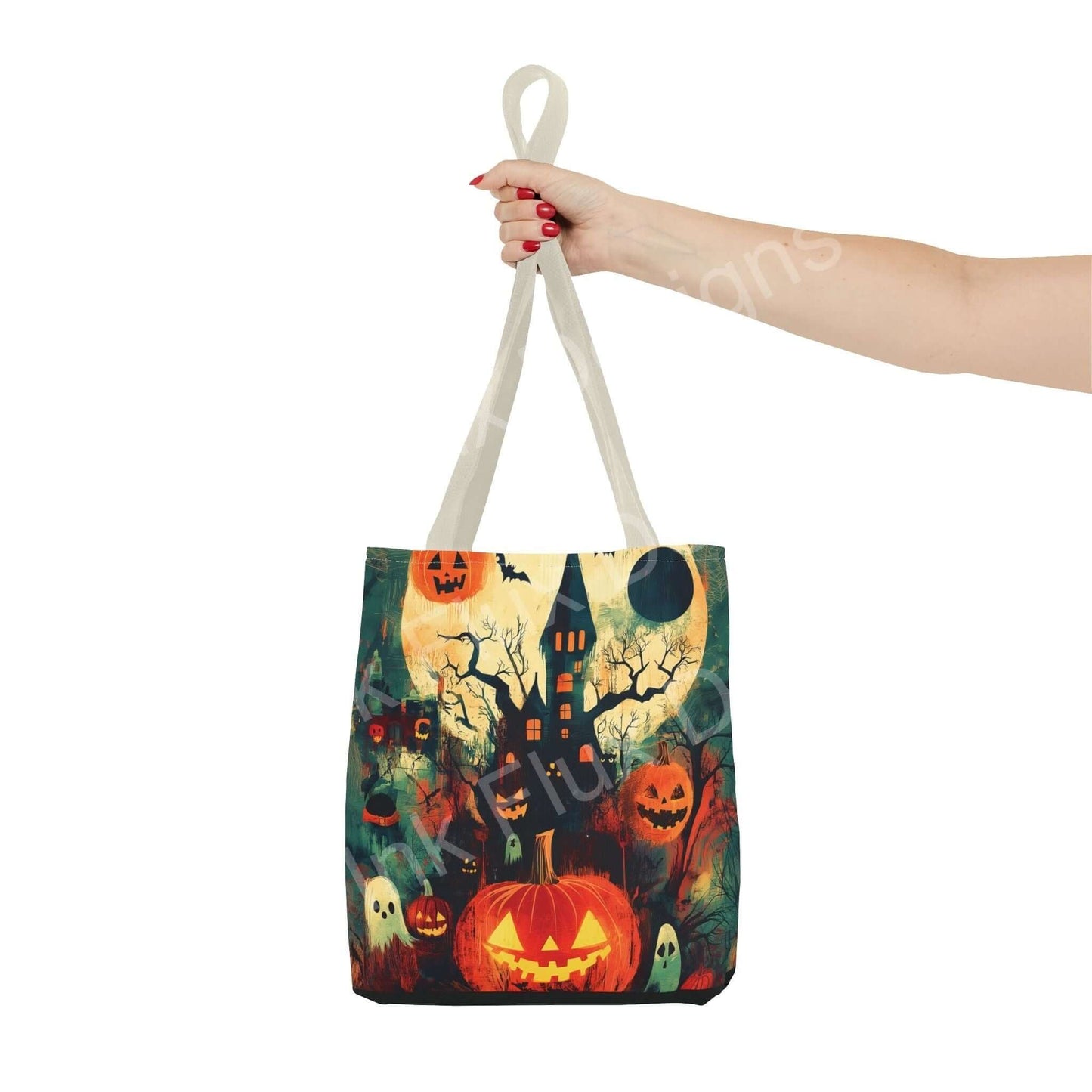 Woman holding a Halloween-themed tote bag featuring an all-over print of a haunted house, pumpkins, and spooky trees.