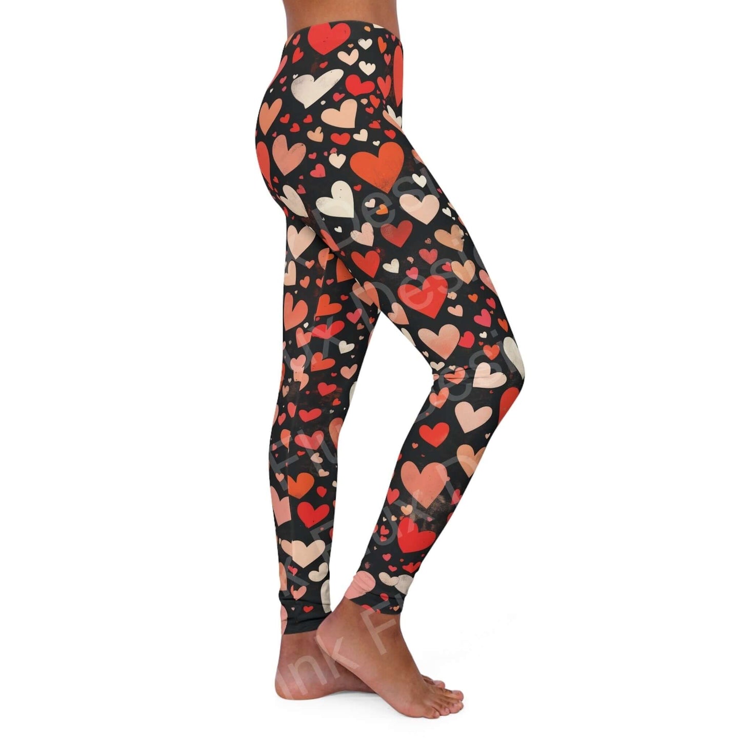 Woman showcasing side view of Hearts Collage Leggings with bold heart patterns, emphasizing the skinny fit and double layer waistband.