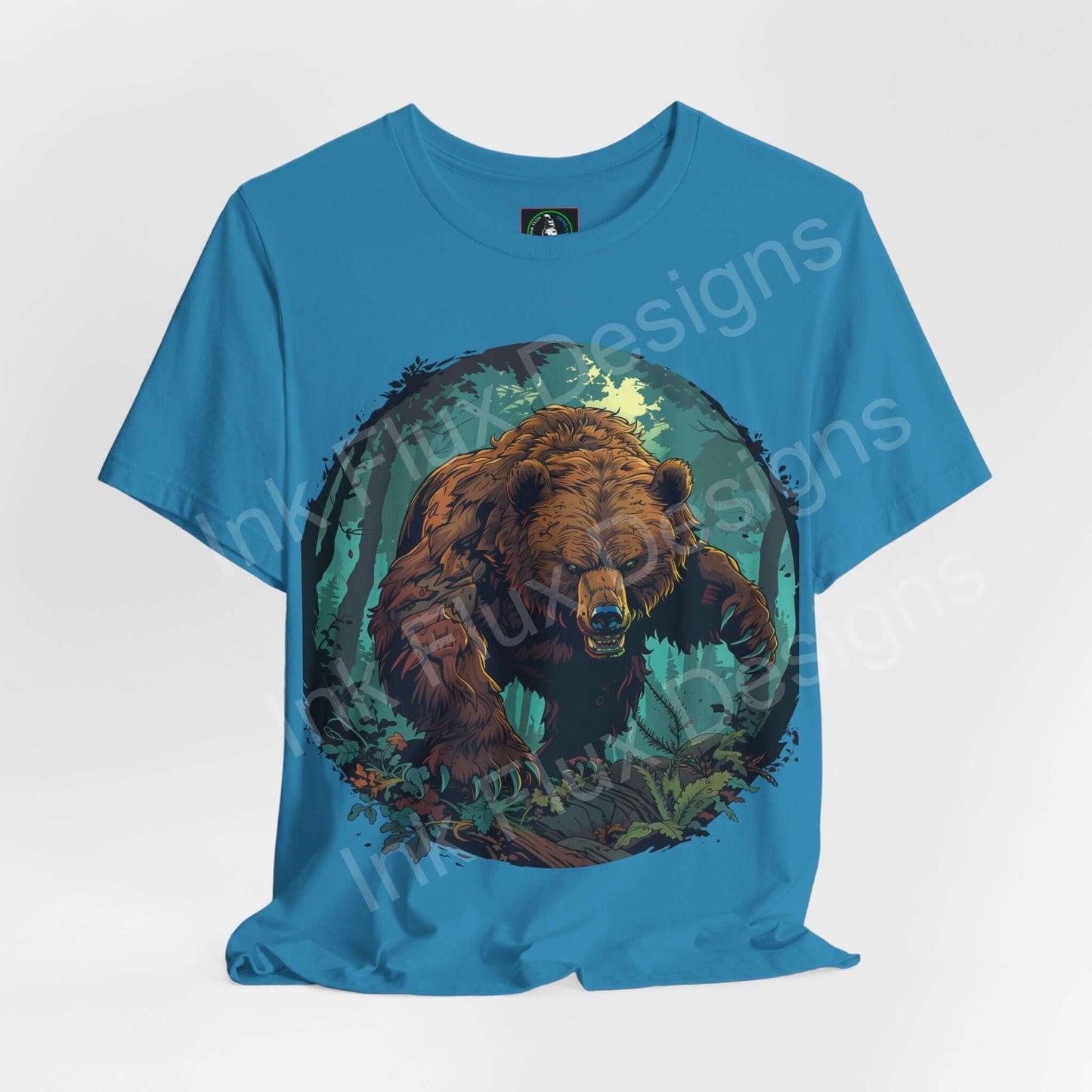 Unisex blue T-shirt with a detailed graphic of a Kodiak bear amid foliage, showcasing spirit animal and ethically made by Bella+Canvas.