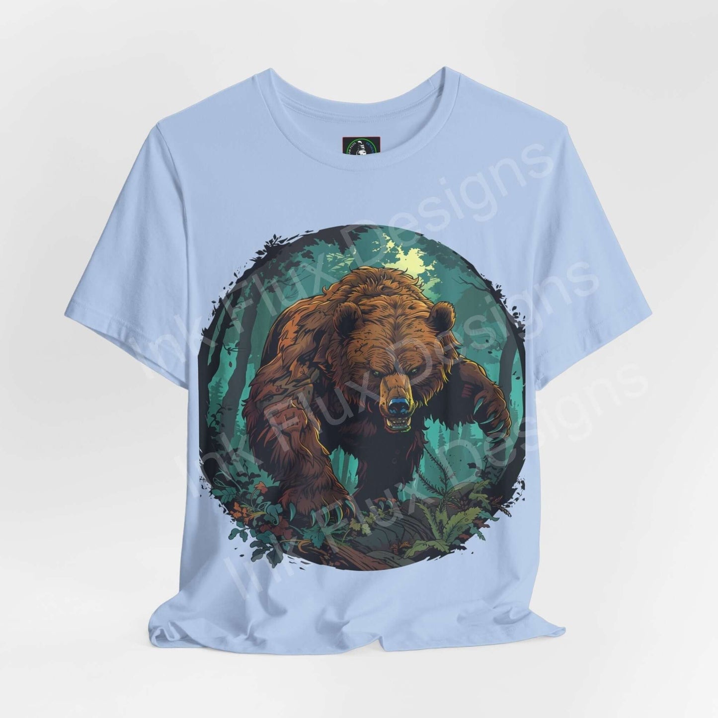 Light blue Kodiak Bear graphic tee showcasing a detailed bear design surrounded by green foliage, ideal for fans of spirit animals and ethically made T-shirts.