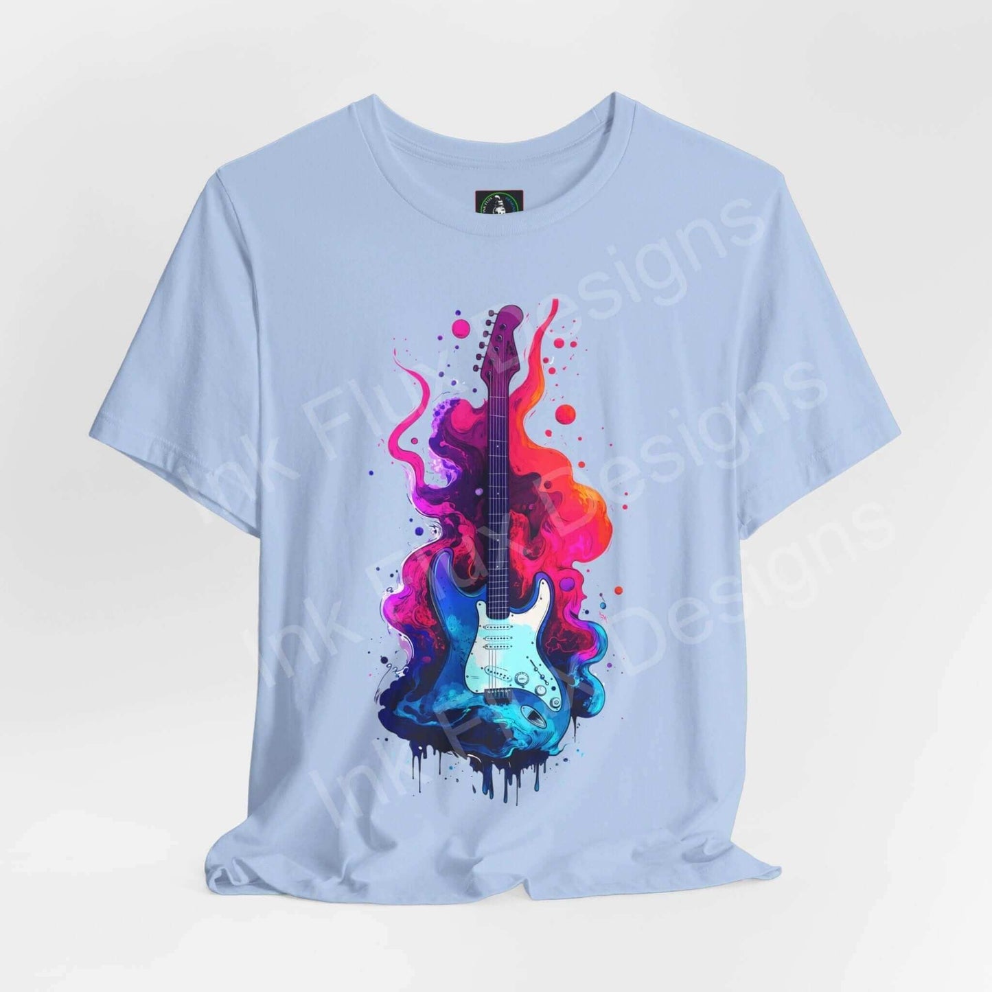 Light blue unisex jersey T-shirt featuring a bold, colorful graphic of a guitar with vibrant paint splashes, from Bella+Canvas.
