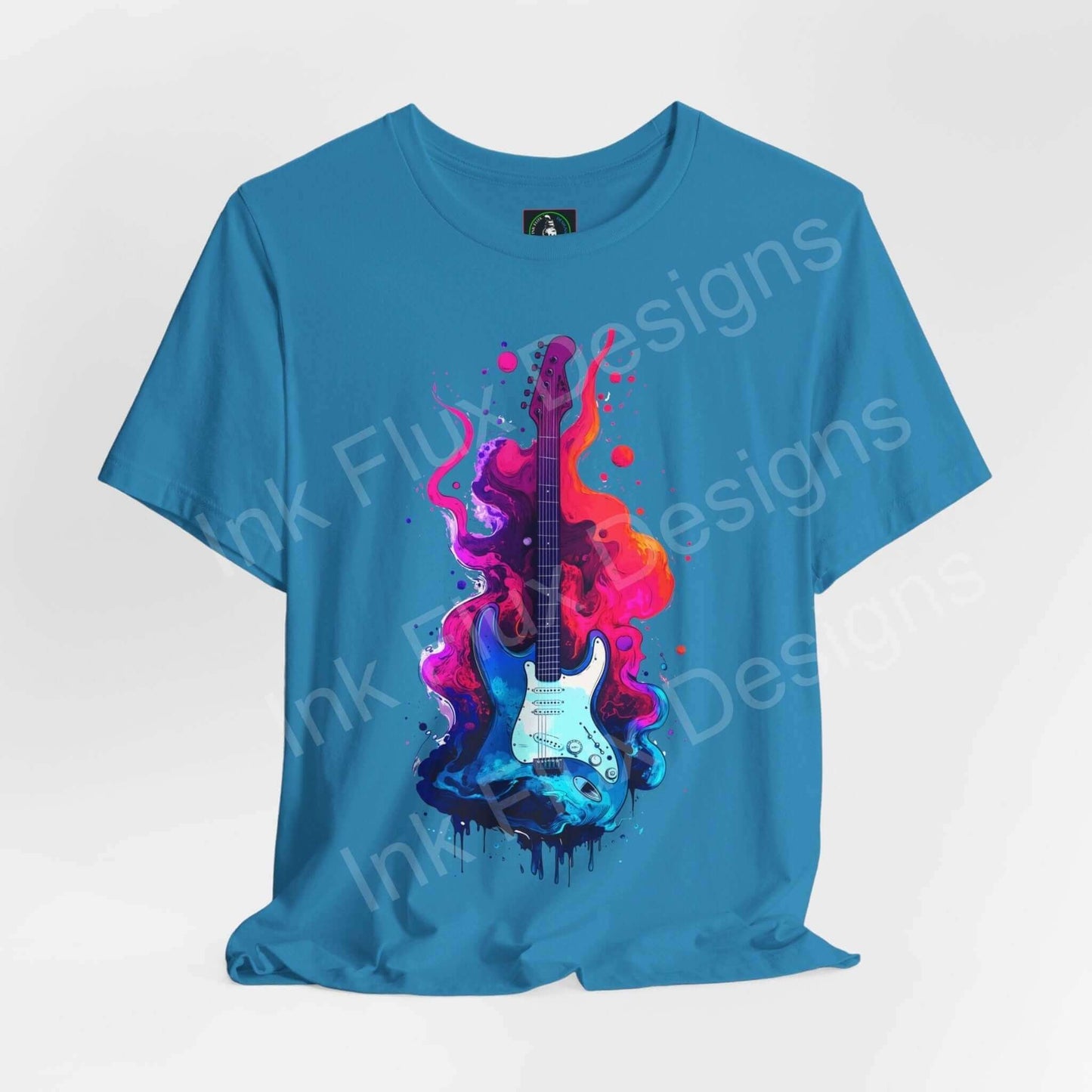 Blue unisex jersey T-shirt featuring bold Liquid Guitar II graphic with vibrant pink and purple splashes, by Bella+Canvas.