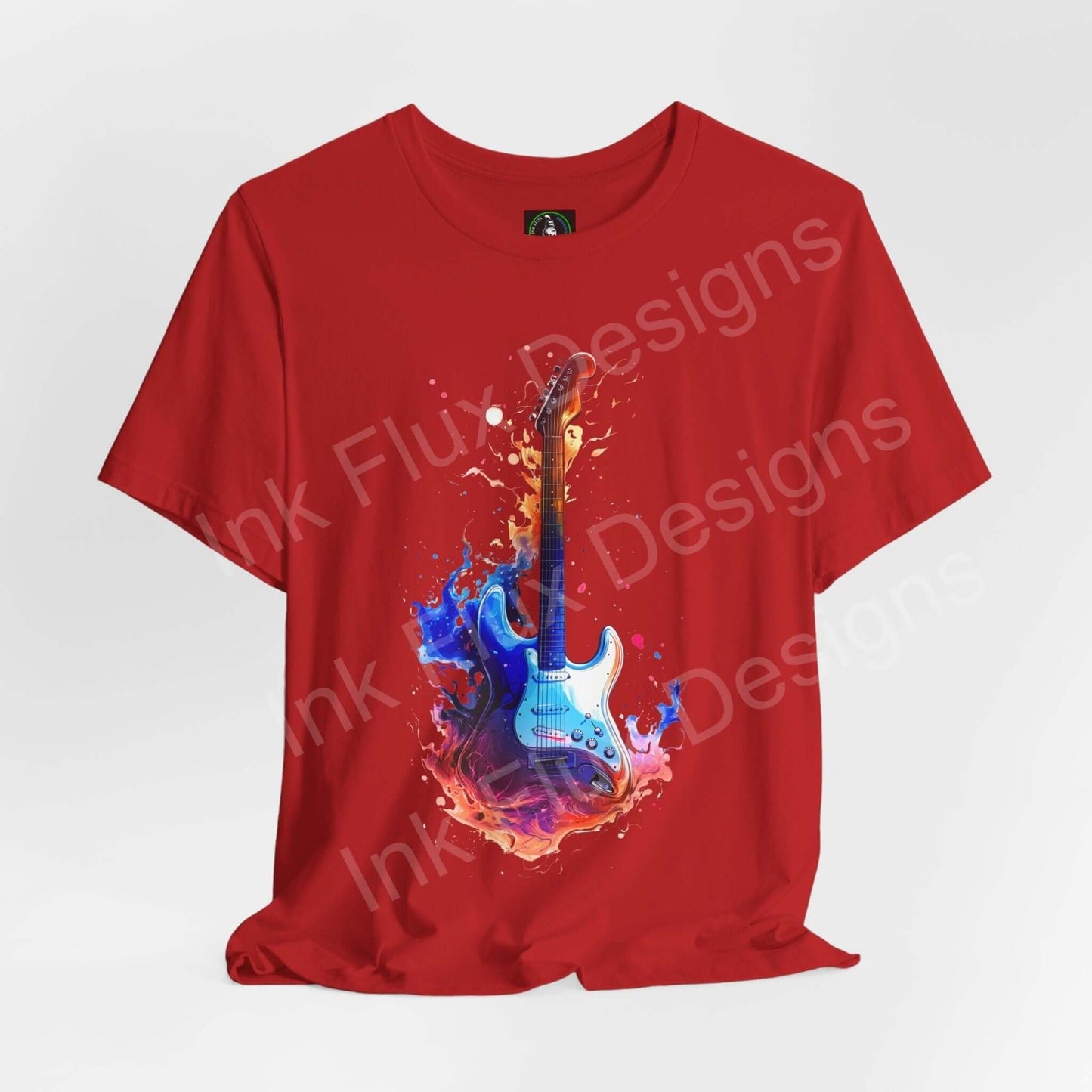 Red unisex jersey T-shirt featuring a bold graphic of a blue guitar with vibrant liquid splash design, crafted from soft Airlume cotton.