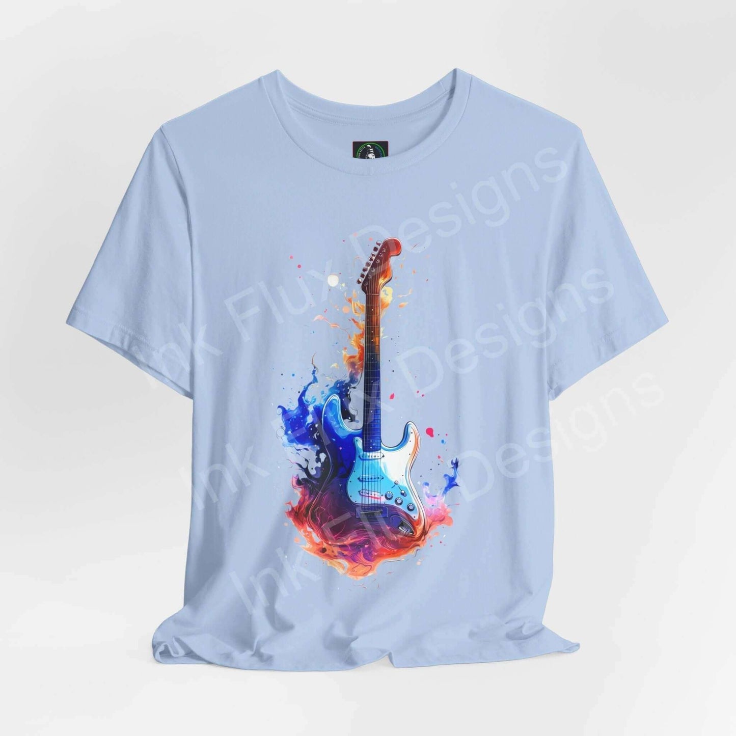 Light blue unisex t-shirt featuring bold graphic of a guitar engulfed in colorful flames, crafted from soft Airlume cotton by Bella+Canvas.