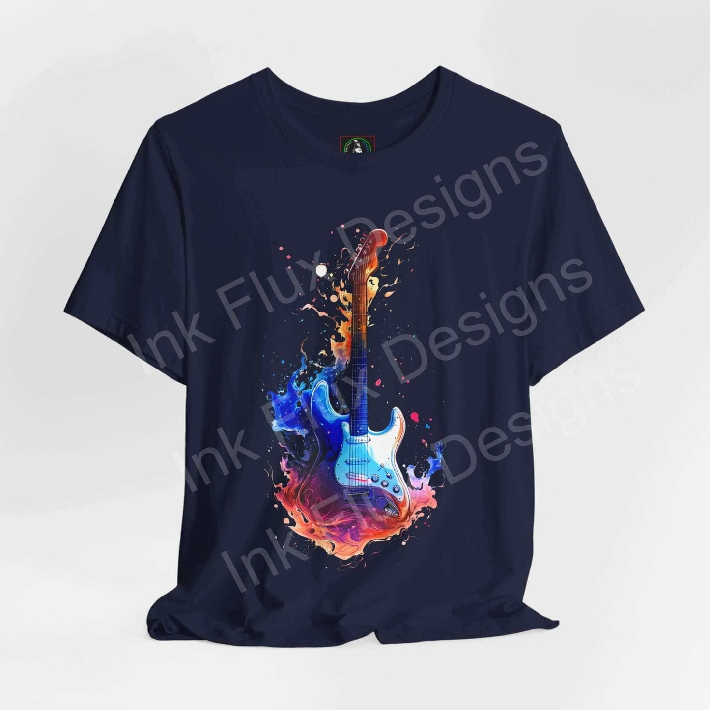 Unisex navy blue T-shirt featuring a vibrant graphic of a guitar with splashes of colorful ink, from Bella+Canvas, ideal for music enthusiasts.