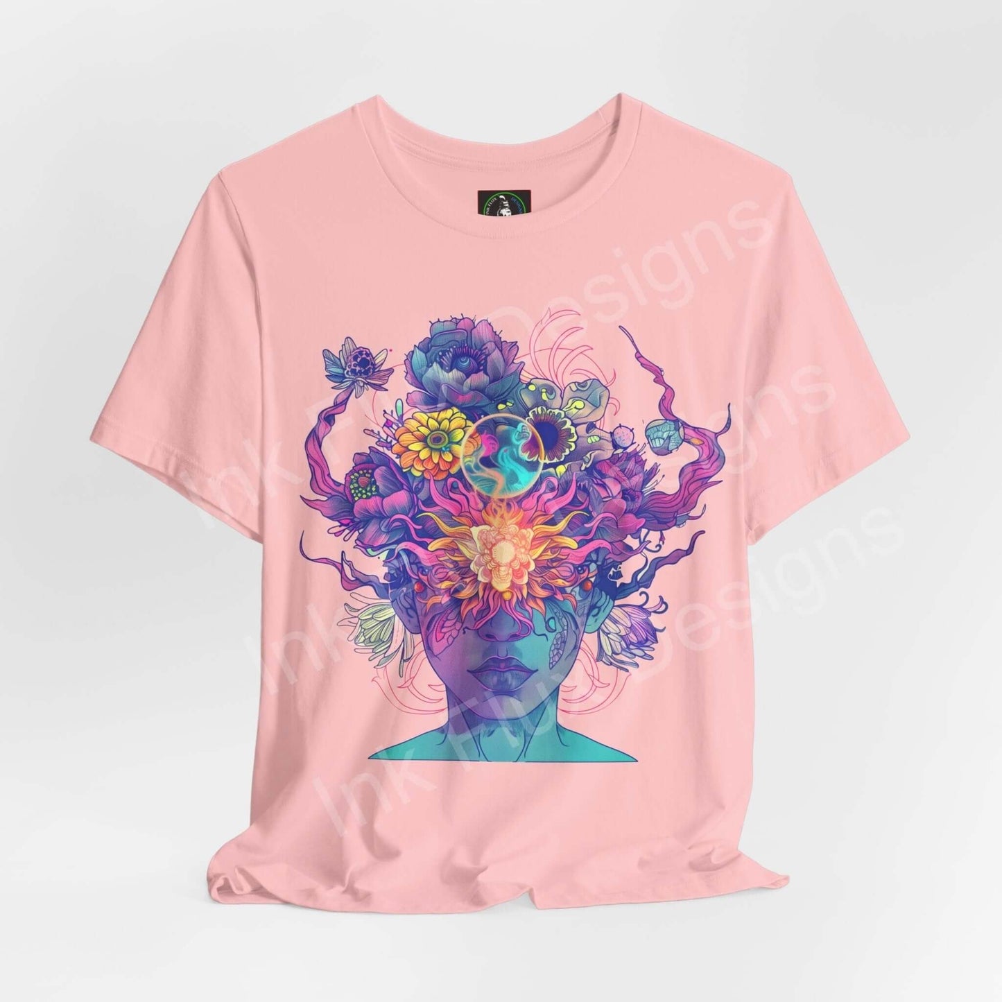 Pink unisex T-shirt with a bold psychedelic graphic of a floral and face illustration, showcasing vibrant colors and artful design for a trippy look.