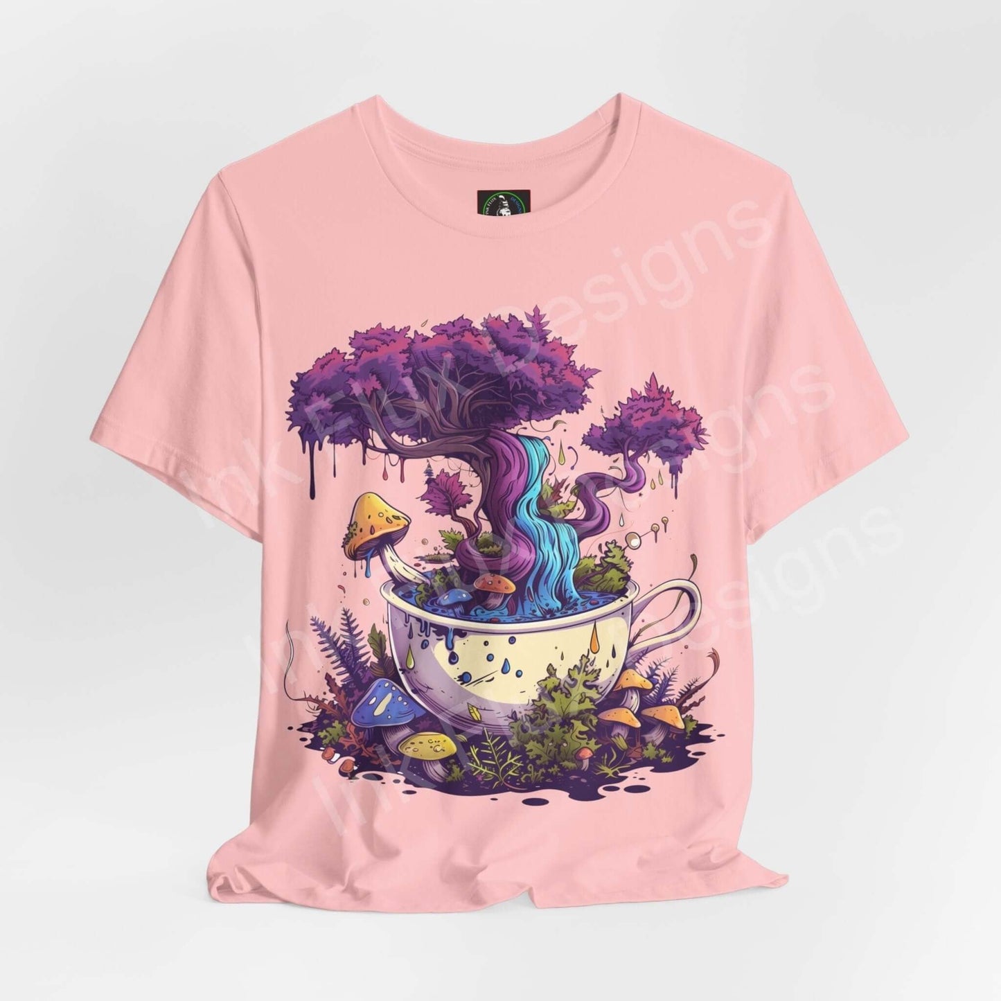 Pink unisex T-shirt featuring bold psychedelic graphic of a whimsical forest growing from a teacup, detailed with trippy, vibrant colors.