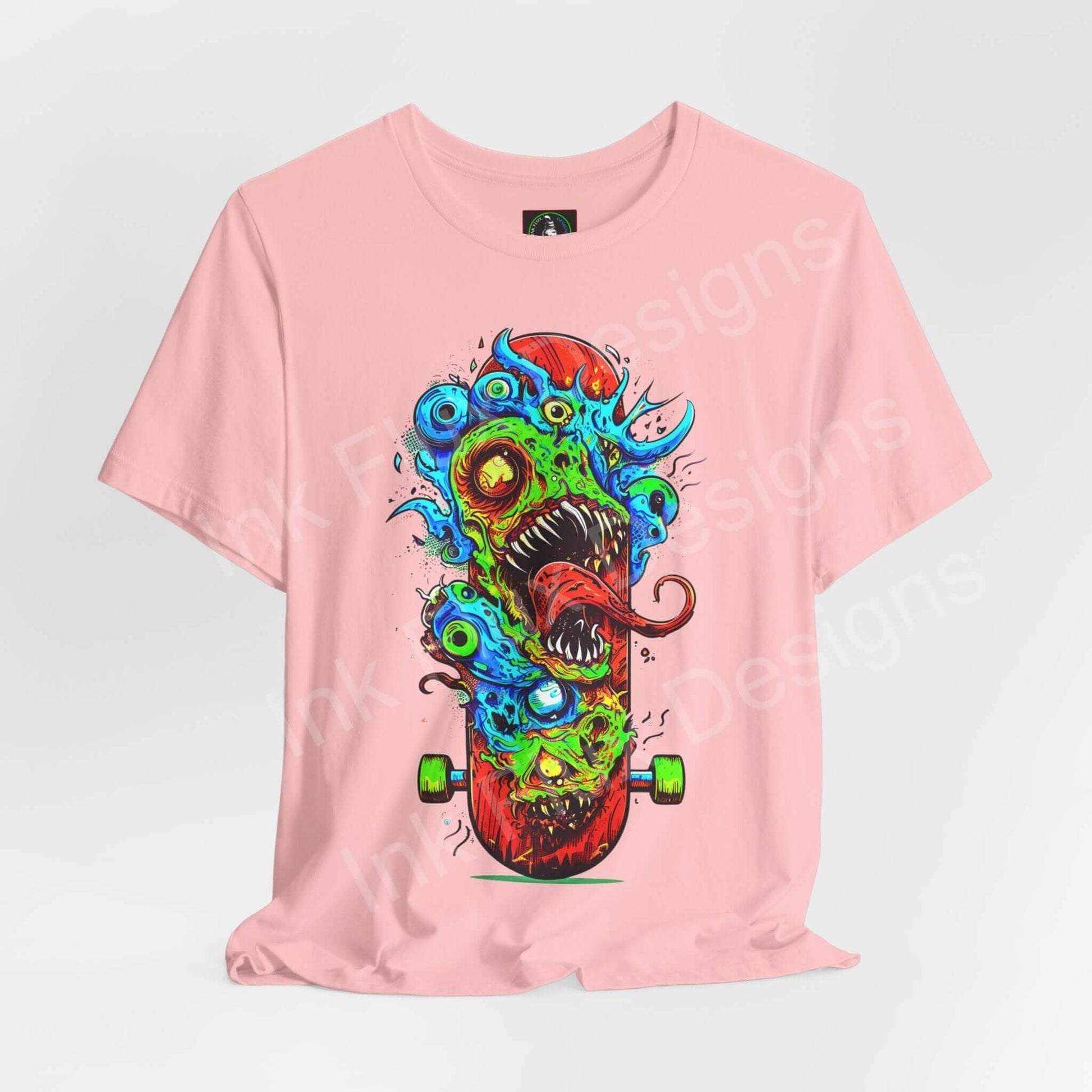 Pink unisex T-shirt featuring bold graphic of a colorful monster on a skateboard, crafted by Bella+Canvas, emphasizing style and comfort.
