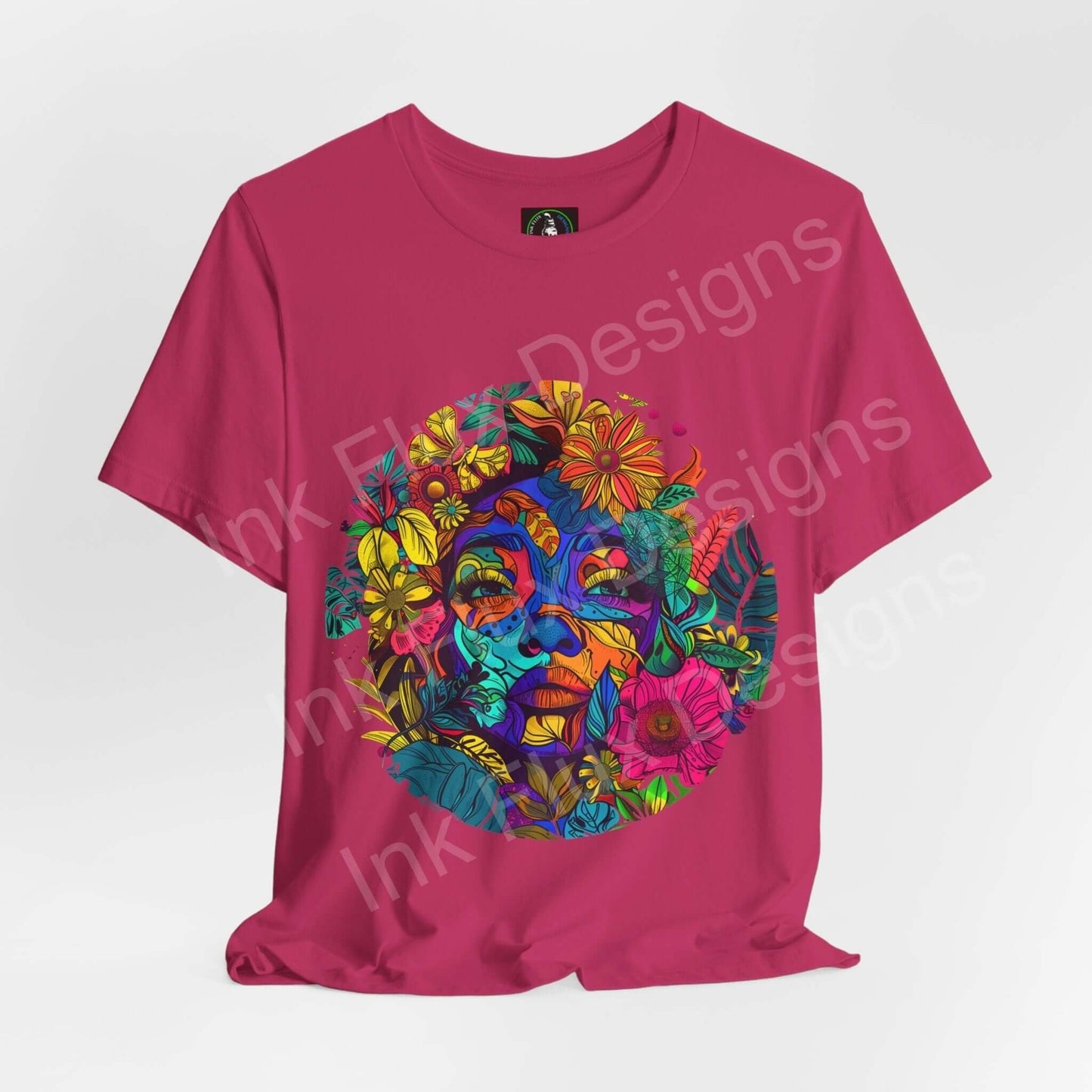 Bold graphic tee featuring a psychedelic, trippy design with vibrant floral and face motifs on a pink unisex T-shirt by Bella+Canvas.