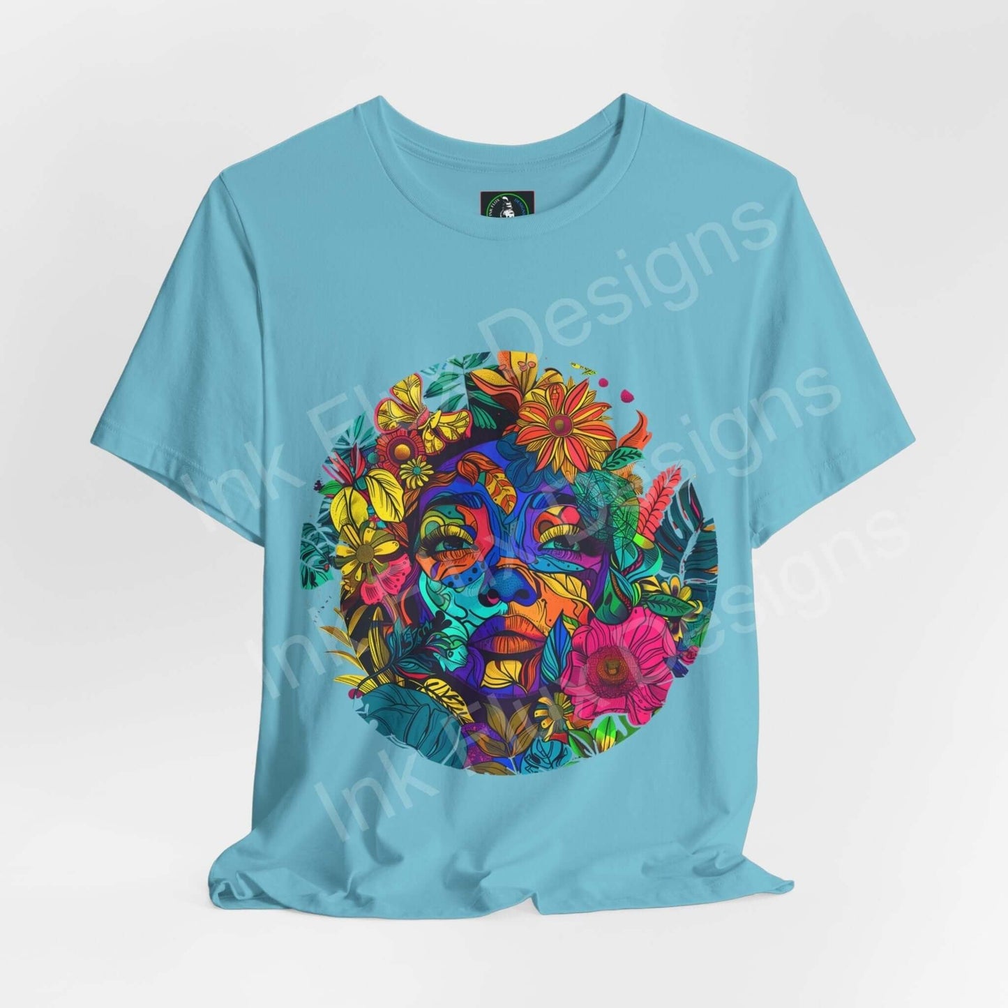 Light blue unisex T-shirt featuring a bold, psychedelic graphic with vibrant floral and trippy face designs, perfect for a stylish, casual look.