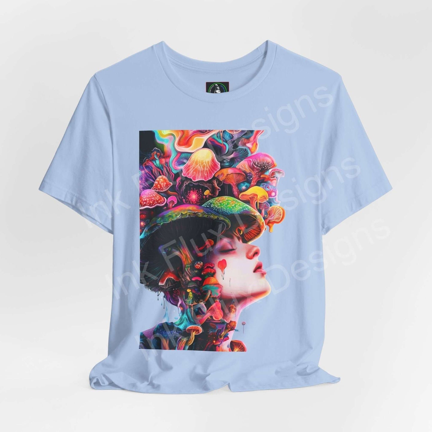 Psychedelic graphic tee featuring trippy mushroom and face design on a light blue unisex T-shirt by Bella+Canvas, showcasing bold graphics and vivid colors.