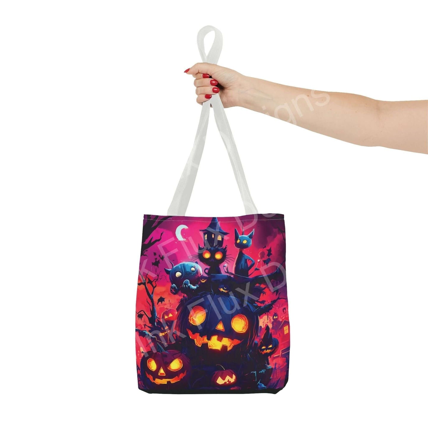 Stylish tote bag featuring vibrant all-over print of jack o' lanterns and eerie cats, held by a hand with white handle straps.