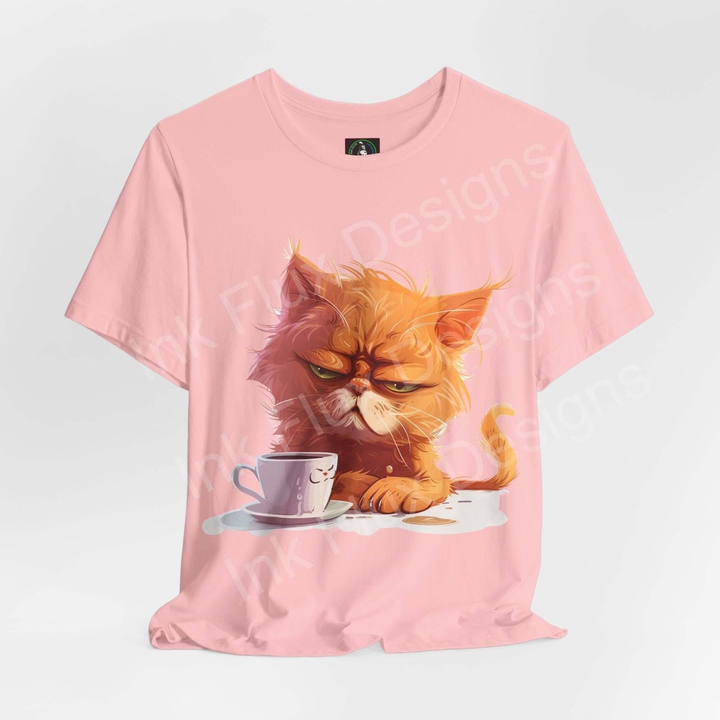 Pink unisex T-shirt featuring a graphic of a grumpy cat with a coffee cup, ideal for cat lovers and casual wear.