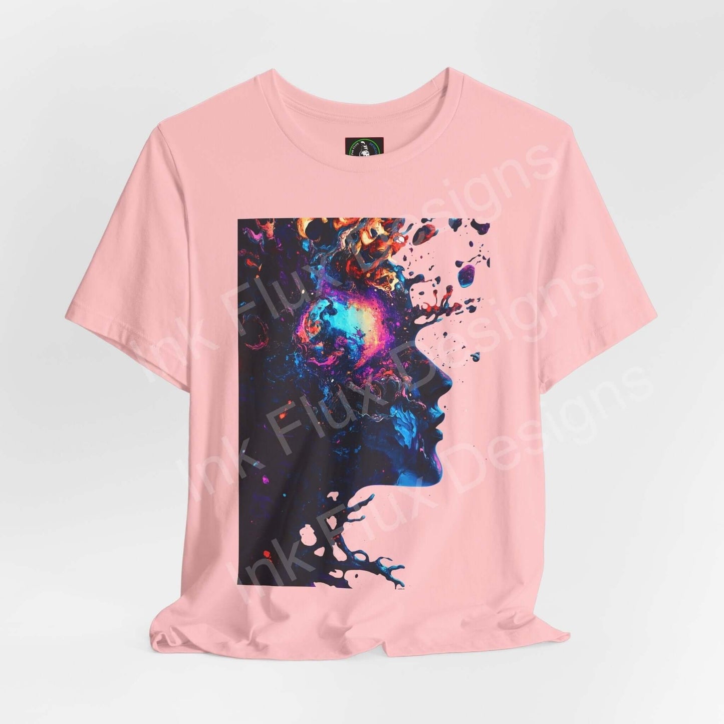 Pink unisex T-shirt featuring a bold, trippy psychedelic graphic of a colorful splattered ink face, ideal for those who love unique graphic tees.