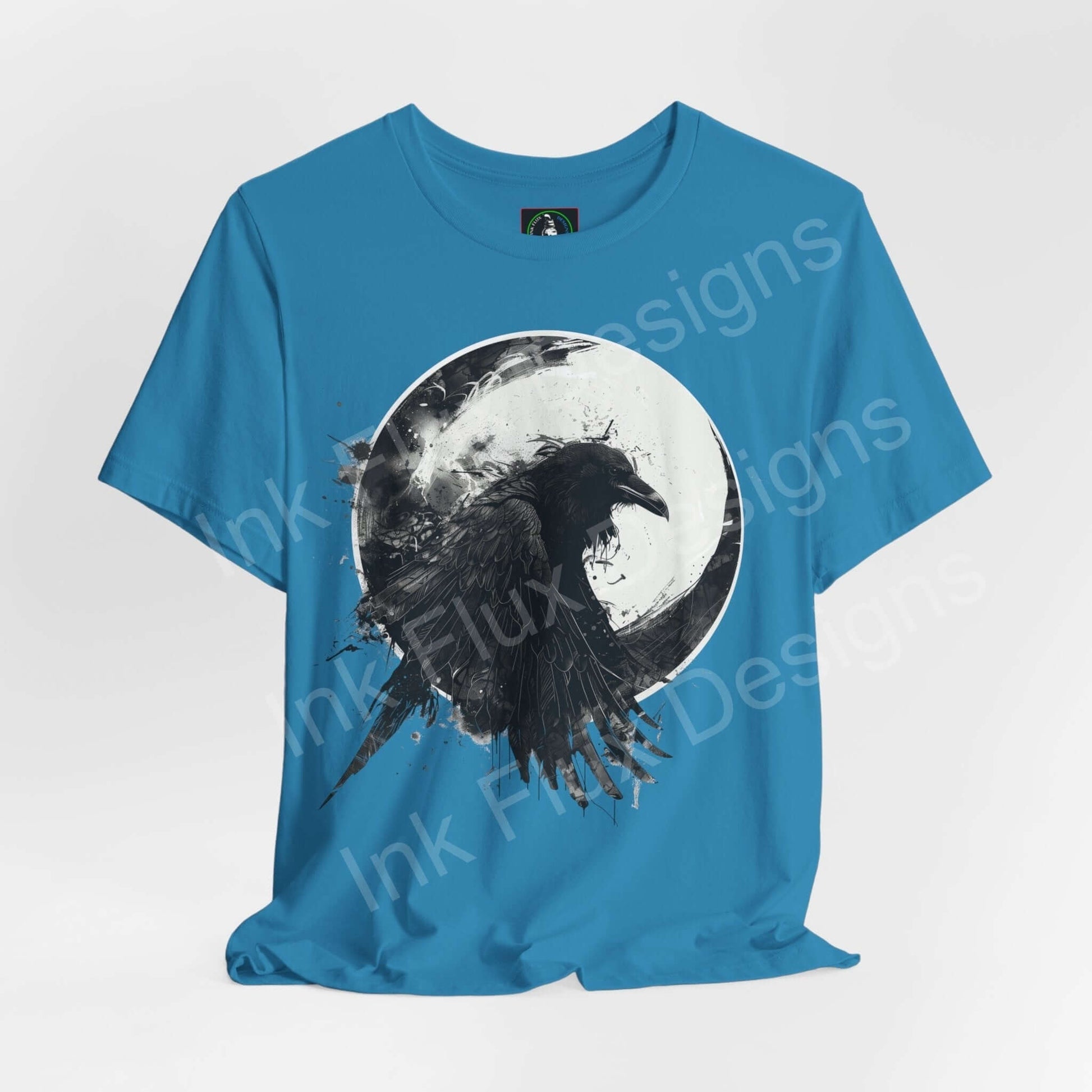 Unisex blue T-shirt featuring a graphic of a raven against a moon, part of the 'Spirit Animals' collection by Bella+Canvas