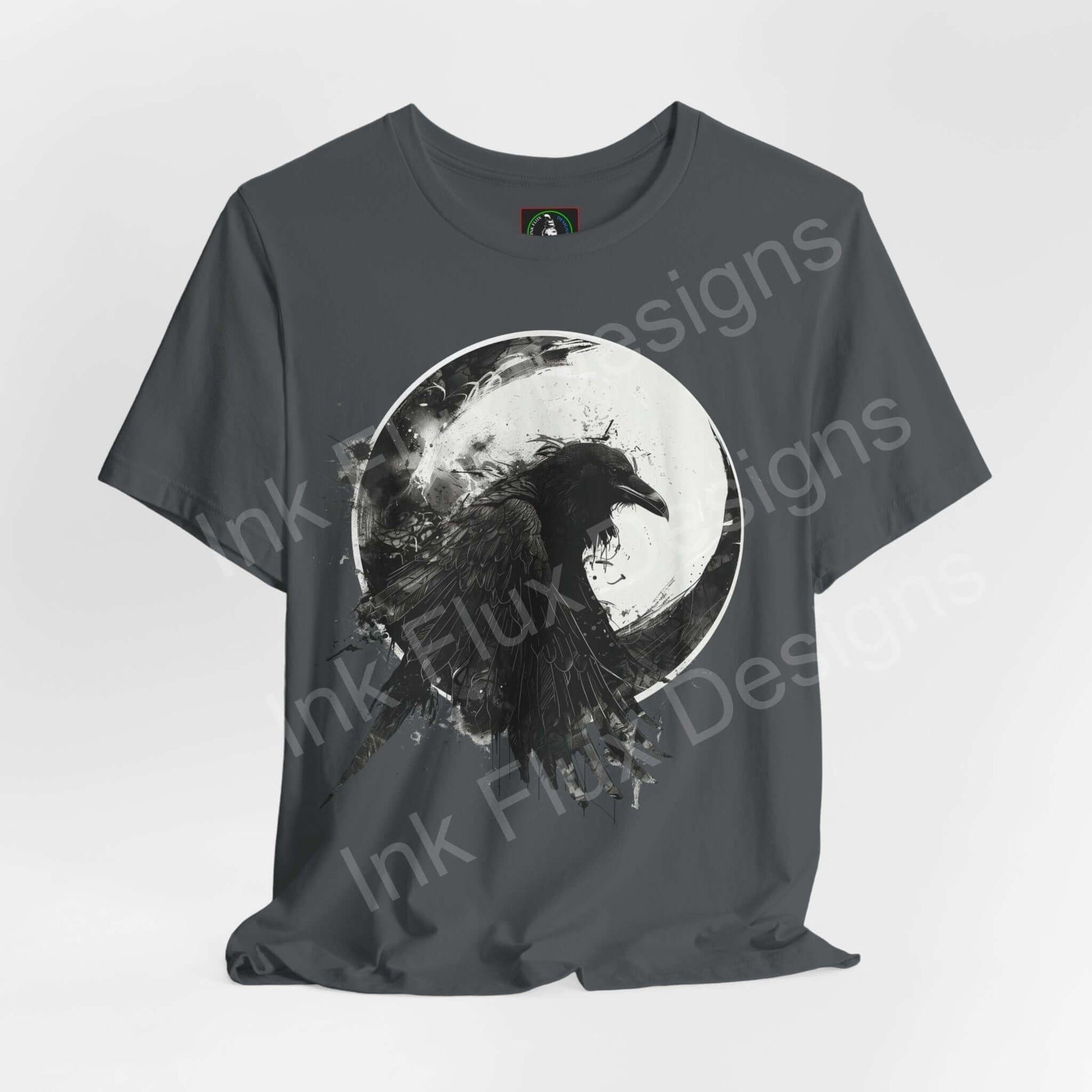 Unisex dark green T-shirt featuring a graphic of a raven against a moon, from the 'The Raven II' collection by Bella+Canvas, emphasizing comfort, style, and sustainability.