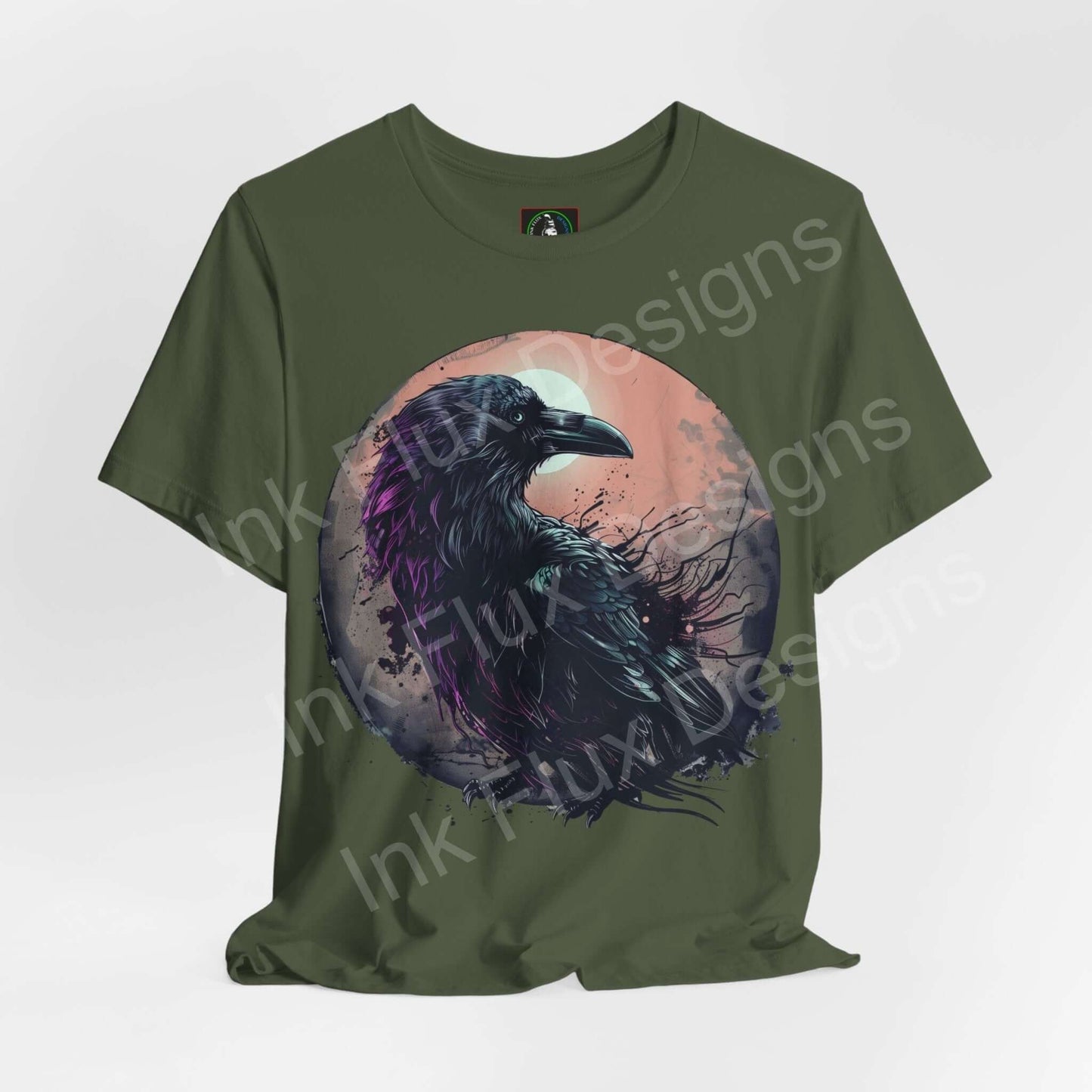 Unisex green T-shirt featuring a graphic of a raven in vibrant purple against a moon, from Bella+Canvas, ideal for spirit animal enthusiasts.