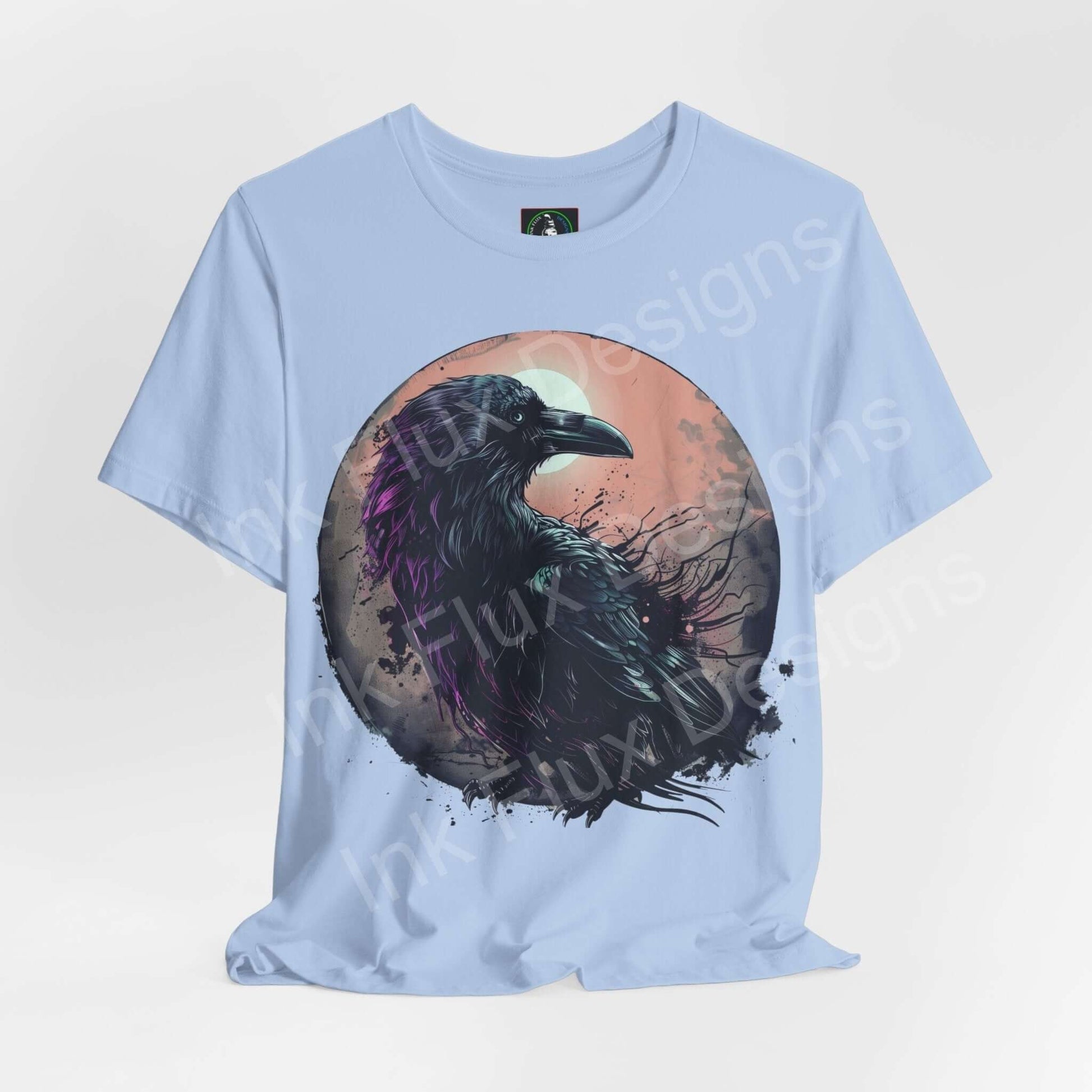 Light blue unisex jersey T-shirt featuring a vibrant graphic of a raven, perfect for fans of spirit animals and graphic tees.