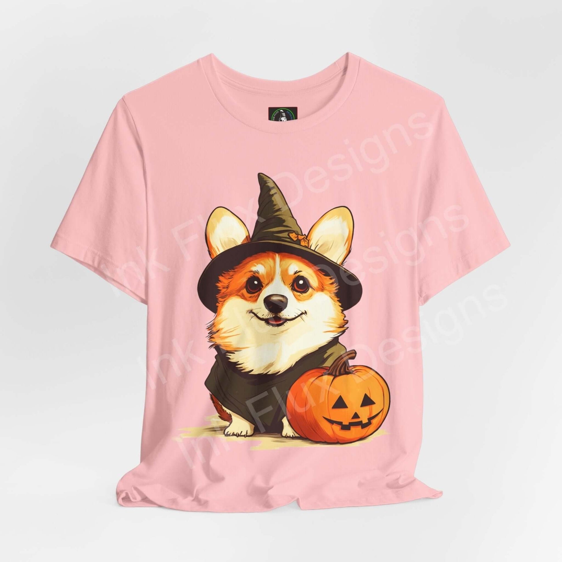 Pink unisex graphic tee featuring a Corgi in a witch hat with a Halloween pumpkin, ideal for Halloween T-shirts lovers.