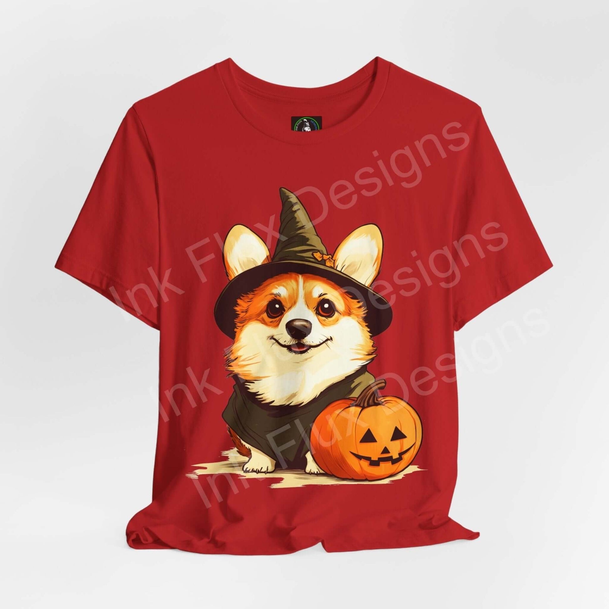 Halloween graphic tee featuring a charming corgi in a witch hat with a pumpkin, on a red unisex T-shirt.