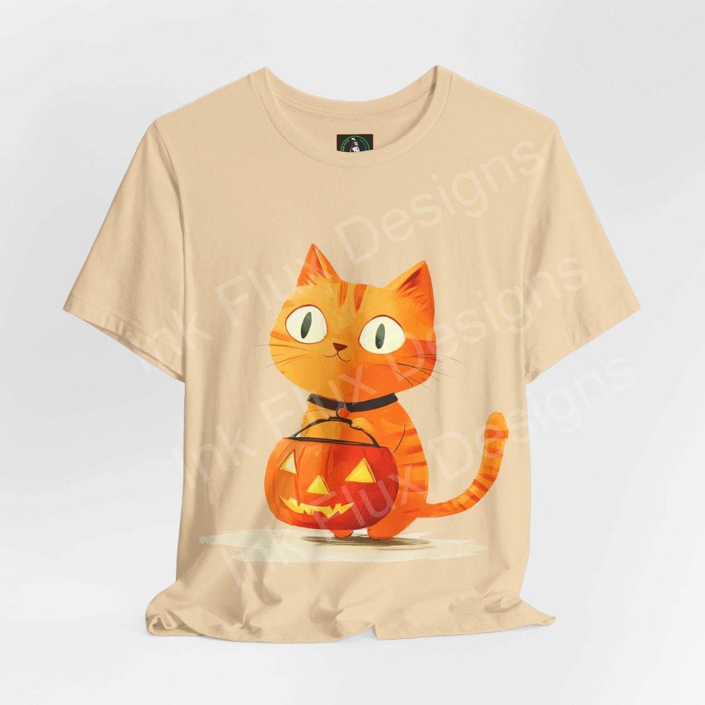 Trick o Treat Orange Cat II graphic tee featuring a cute orange cat with a pumpkin on a beige T-shirt, perfect for Halloween.