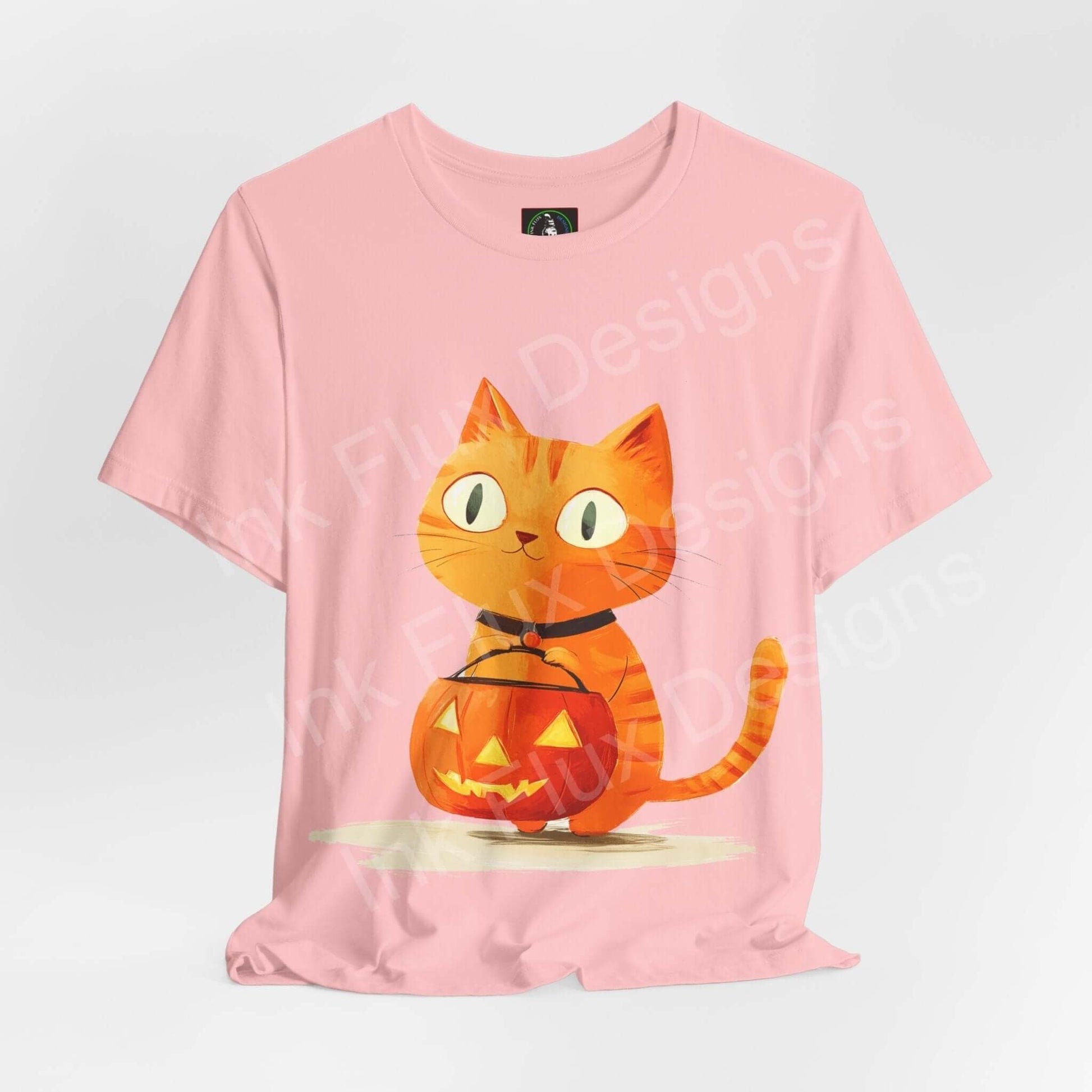 Pink unisex T-shirt featuring a graphic of an orange cat with a Halloween pumpkin, ideal for Halloween-themed graphic tees.