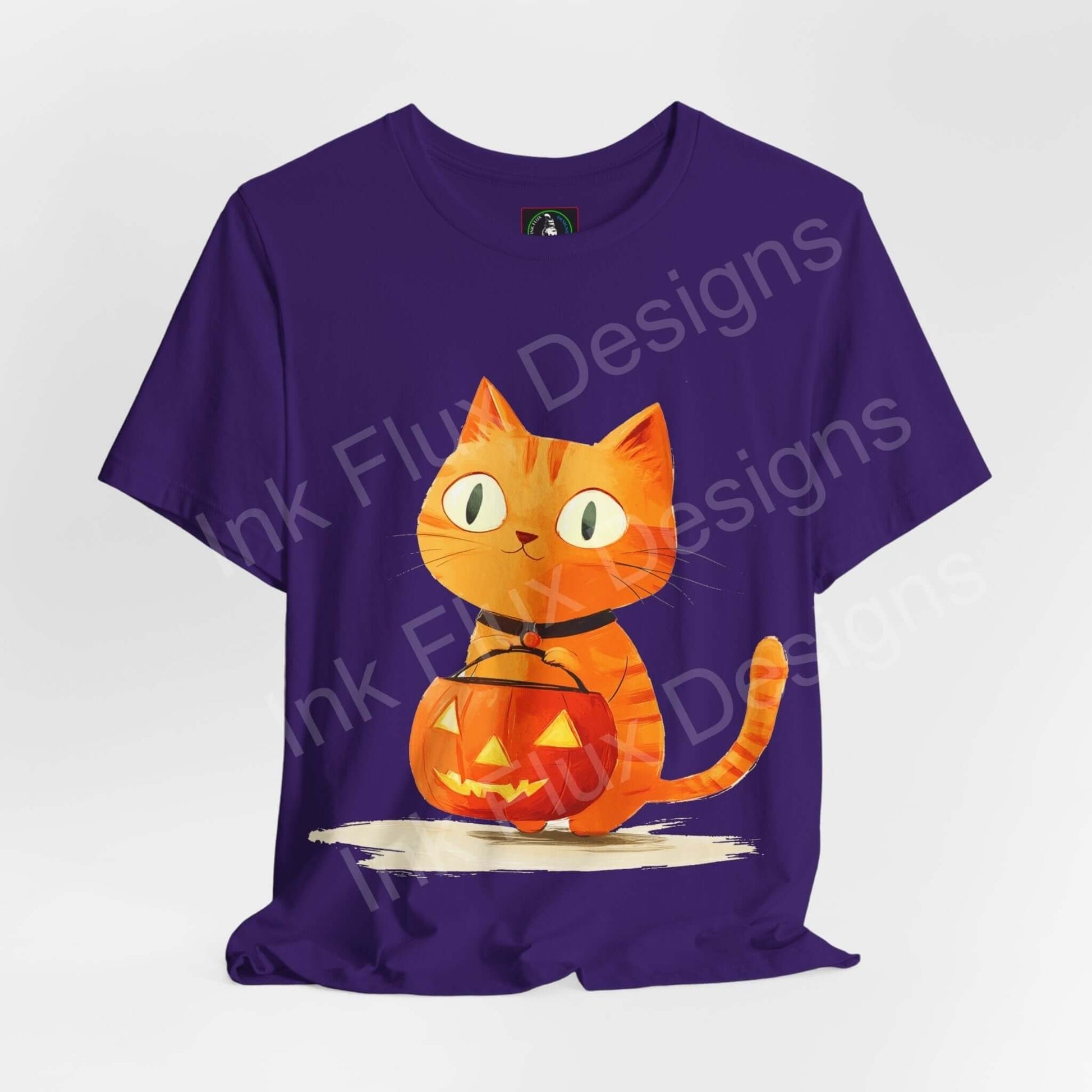 Purple Halloween T-shirt featuring a graphic design of a cute orange cat with a jack-o'-lantern on a unisex jersey tee.