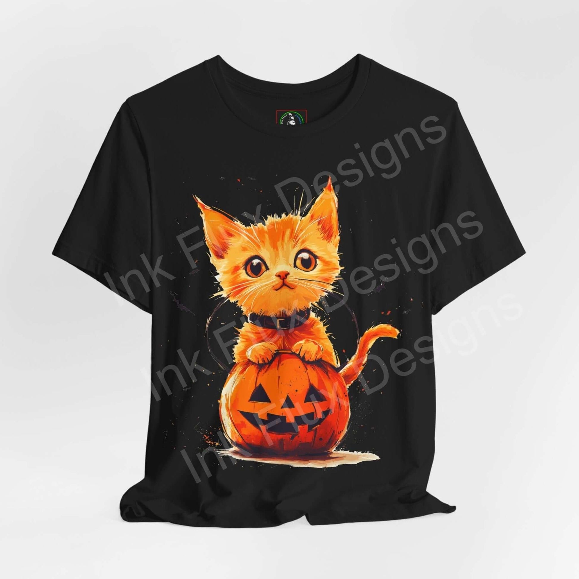 Halloween-themed black T-shirt featuring a graphic of an orange cat sitting in a pumpkin, ideal for festive graphic tees.