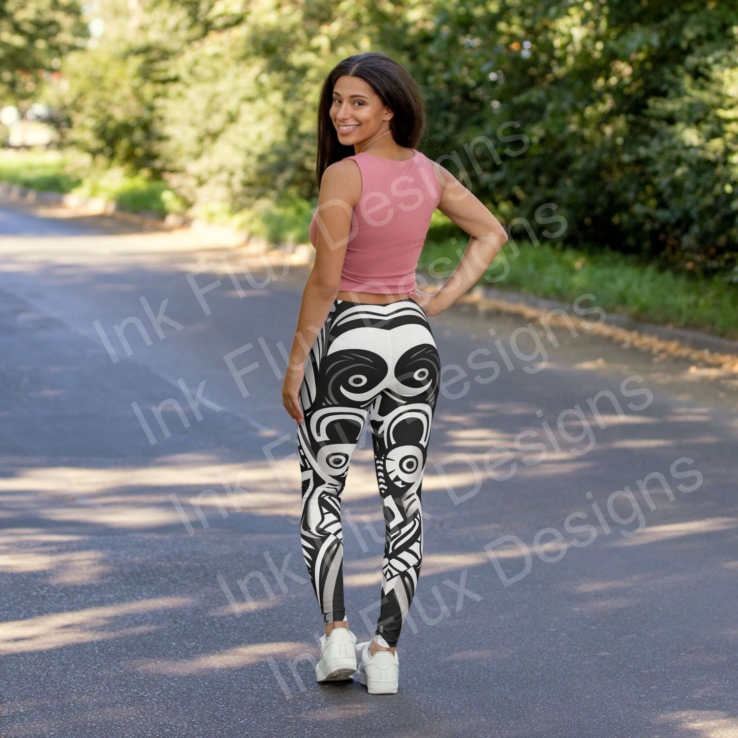 Woman in pink top and bold-designed Trippy VIII leggings smiling on a sunny street, showcasing the stylish back view of the stretchy, durable athleisure wear.