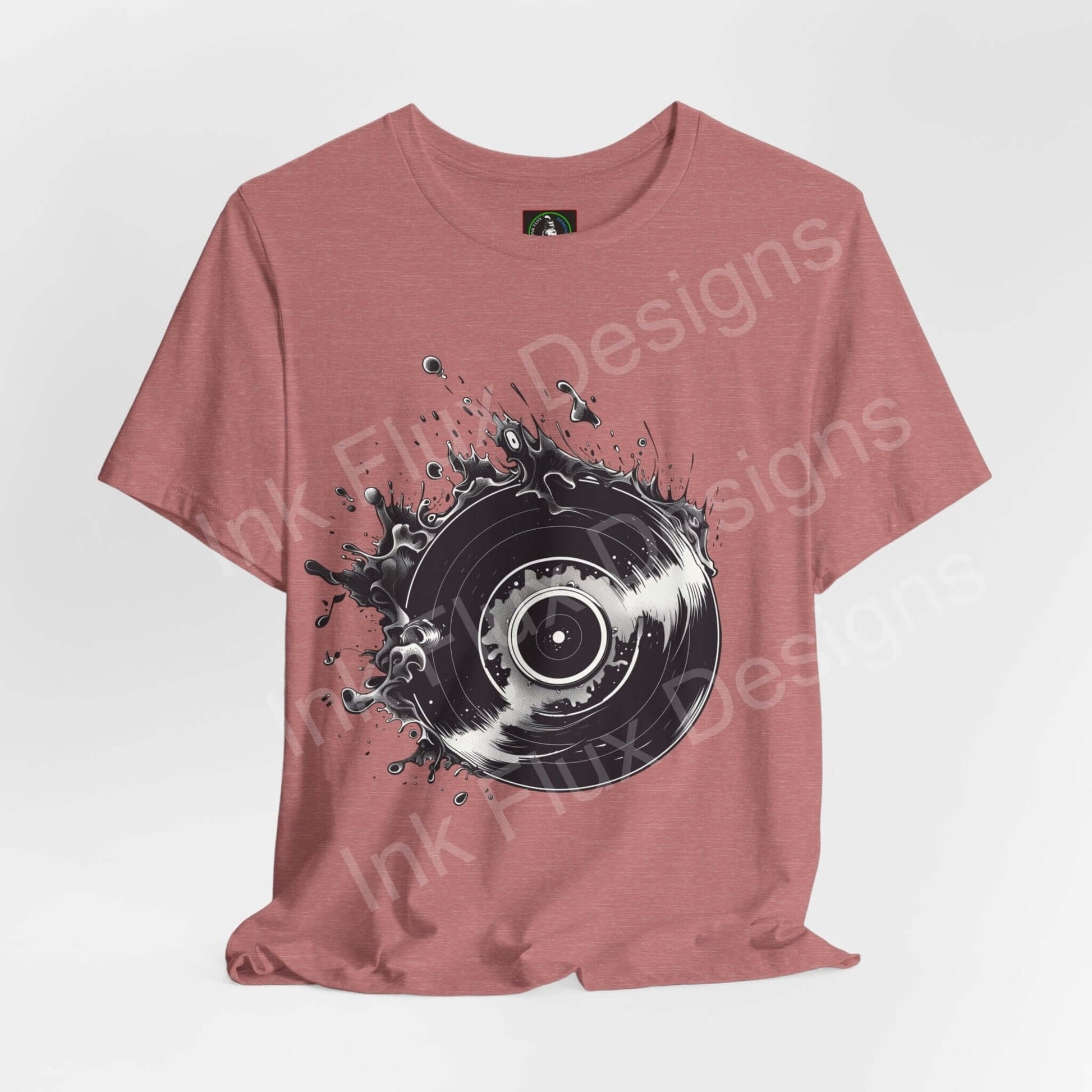Unisex rose-colored T-shirt featuring a bold graphic of a vinyl record with splash design, crafted by Bella+Canvas for style and sustainability.