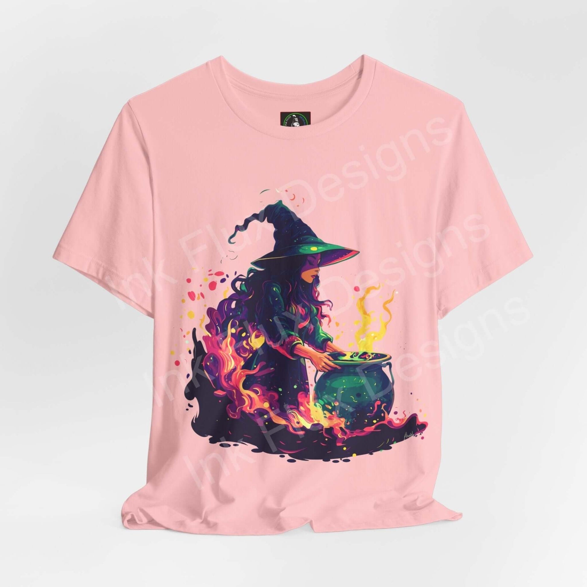 Halloween-themed pink T-shirt with a vivid graphic of a witch brewing a potion, ideal for showcasing stylish and comfortable graphic tees.