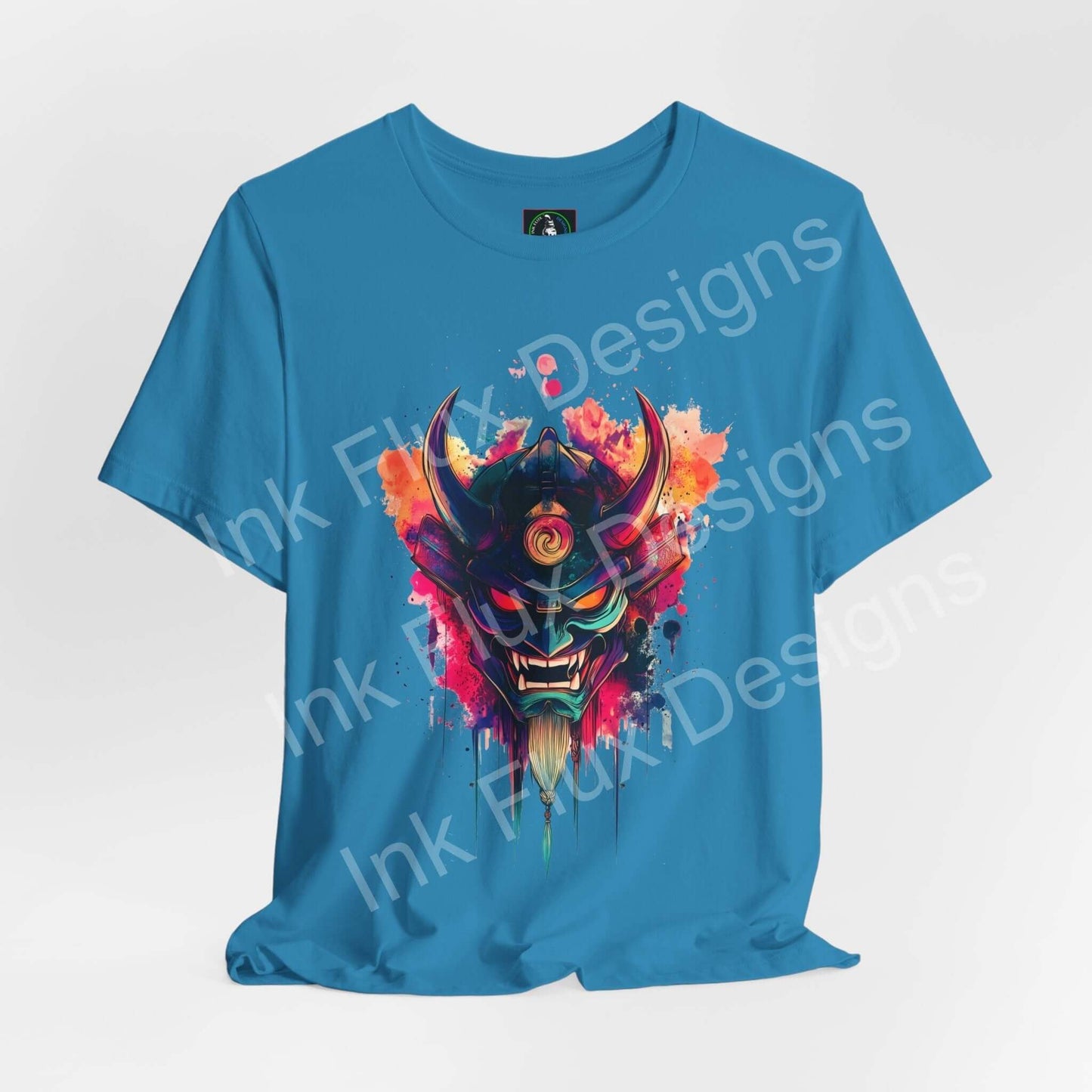 Oni mask graphic t-shirt by Ink Flux Designs, featuring vibrant colors on a blue short sleeve tee.