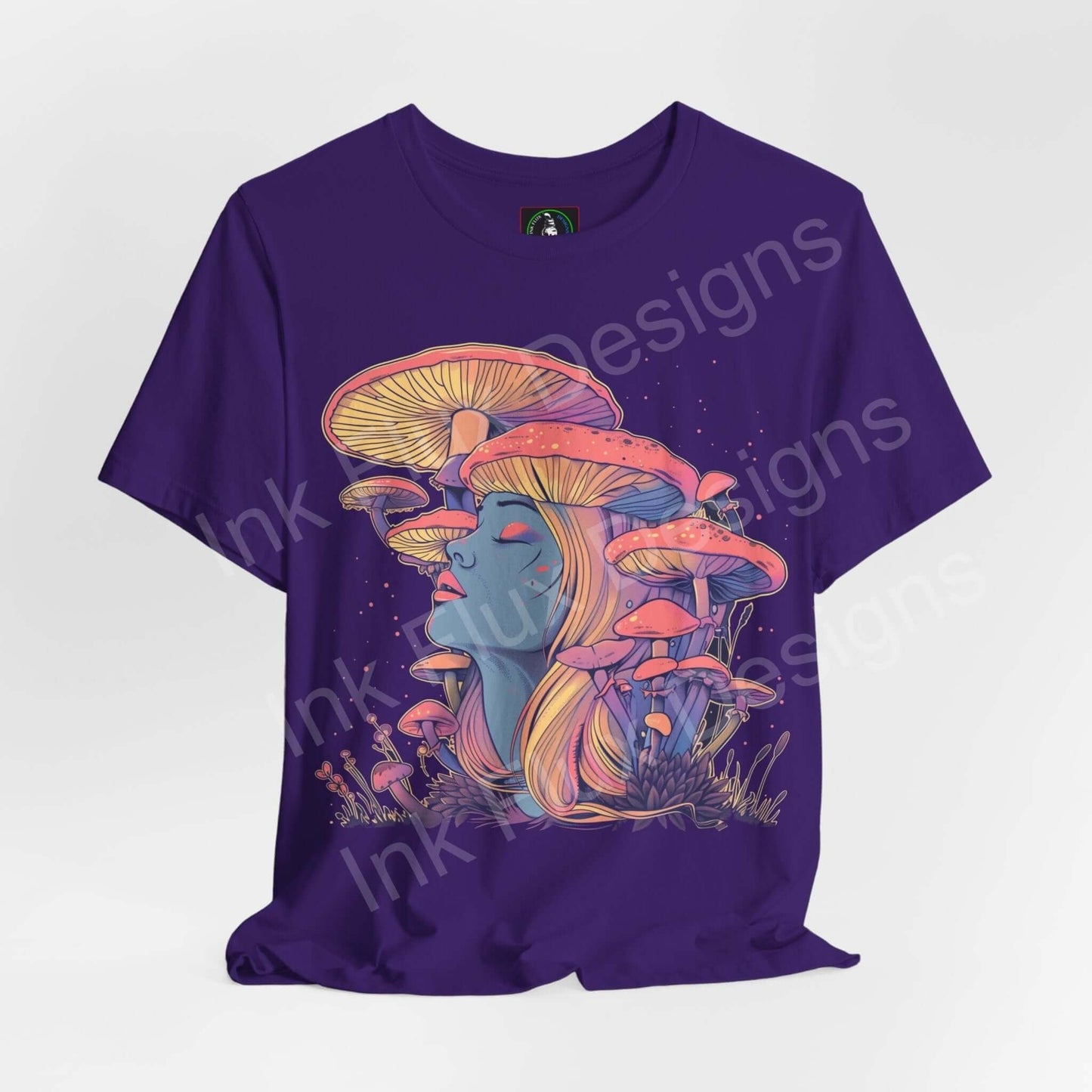Trippy purple T-shirt featuring a psychedelic mushroom and female face design, bold graphics, from Bella+Canvas