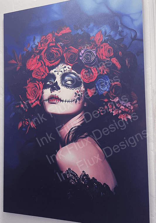 Striking canvas print of a woman with Day of the Dead makeup surrounded by vibrant red and blue roses, displayed in a gallery, by Ink Flux Designs.