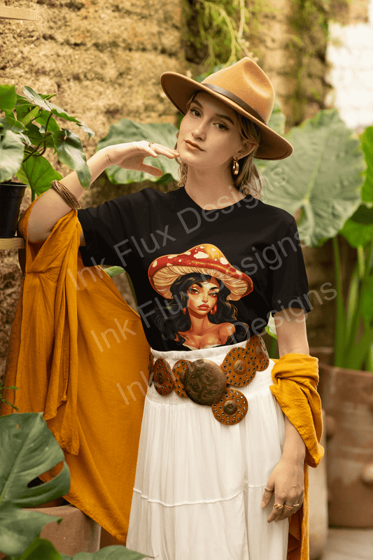 Stylish woman in a garden wearing a T-shirt featuring a psychedelic mushroom hat design, paired with a white skirt and tan fedora.