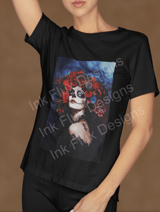 Woman in a black T-shirt featuring a vibrant Day of the Dead design with skull and red roses by Ink Flux Designs
