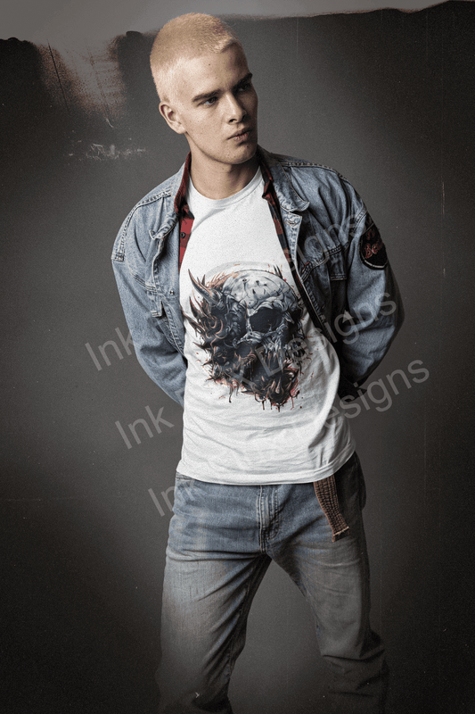 Stylish man in denim jacket and jeans wearing a white T-shirt with a detailed ravenous skull design from Inkflux Designs.