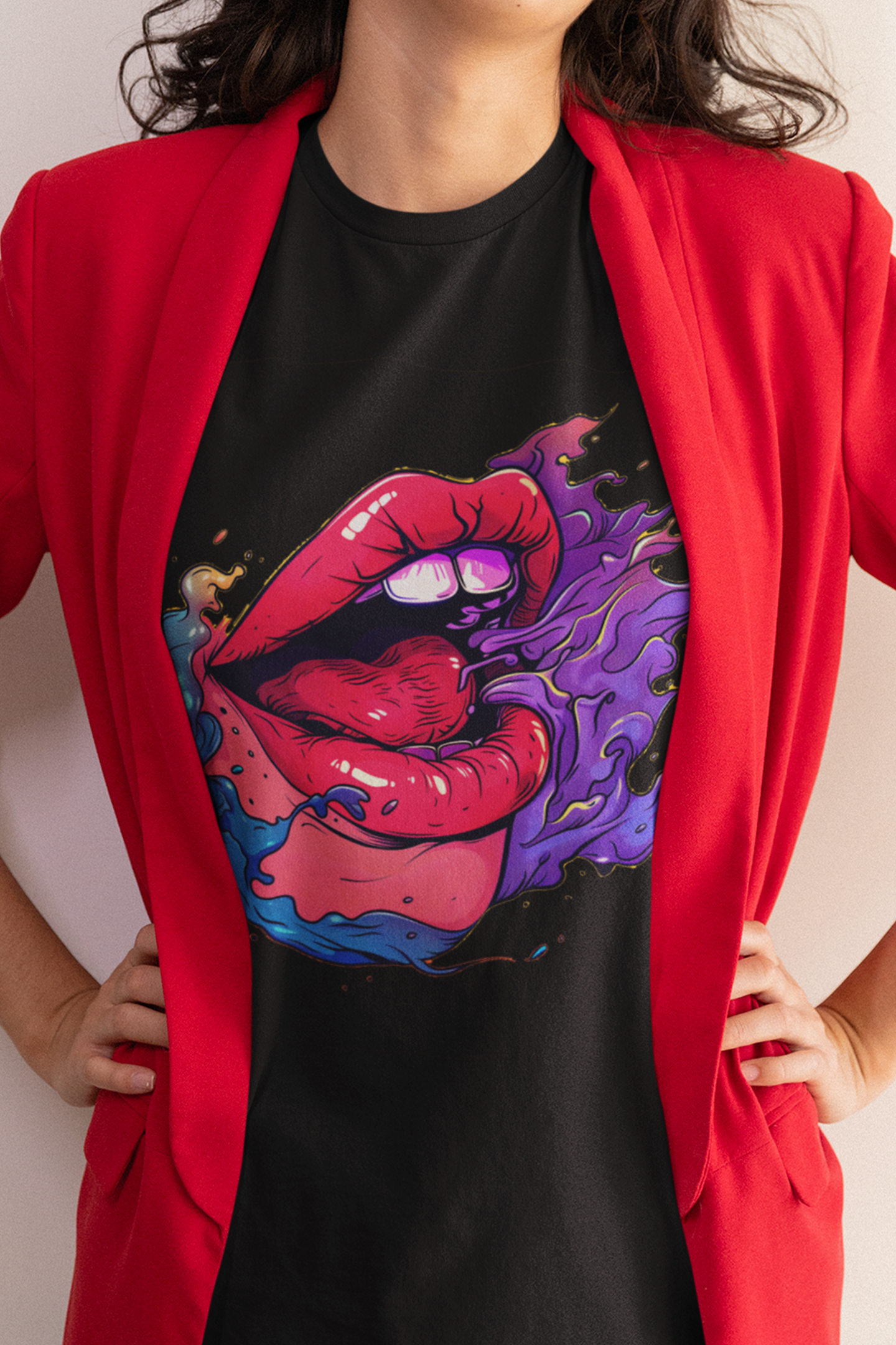 Woman wearing a fun graphic t-shirt with a vibrant lips design under a red blazer, showcasing artistic flair
